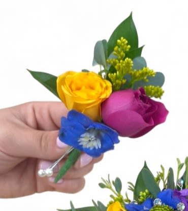 Custom Boutonniere (Pin-On or Pocket) - A custom boutonniere is a uniquely crafted floral accessory designed to complement an individual's attire for special occasions such as weddings, proms, or formal events. Each boutonniere is tailored to reflect the personality and style of the wearer, often featuring a curated selection of fresh flowers, greenery, and decorative elements like ribbons or pins.   The design can range from classic to contemporary, incorporating seasonal blooms and personalized touches that resonate with the event’s theme. Whether it’s a single elegant rose, a cluster of wildflowers, or a sleek and minimalist design, a custom boutonniere adds a distinctive flair to any outfit, making it a meaningful statement piece that celebrates individual expression and connection to the occasion.