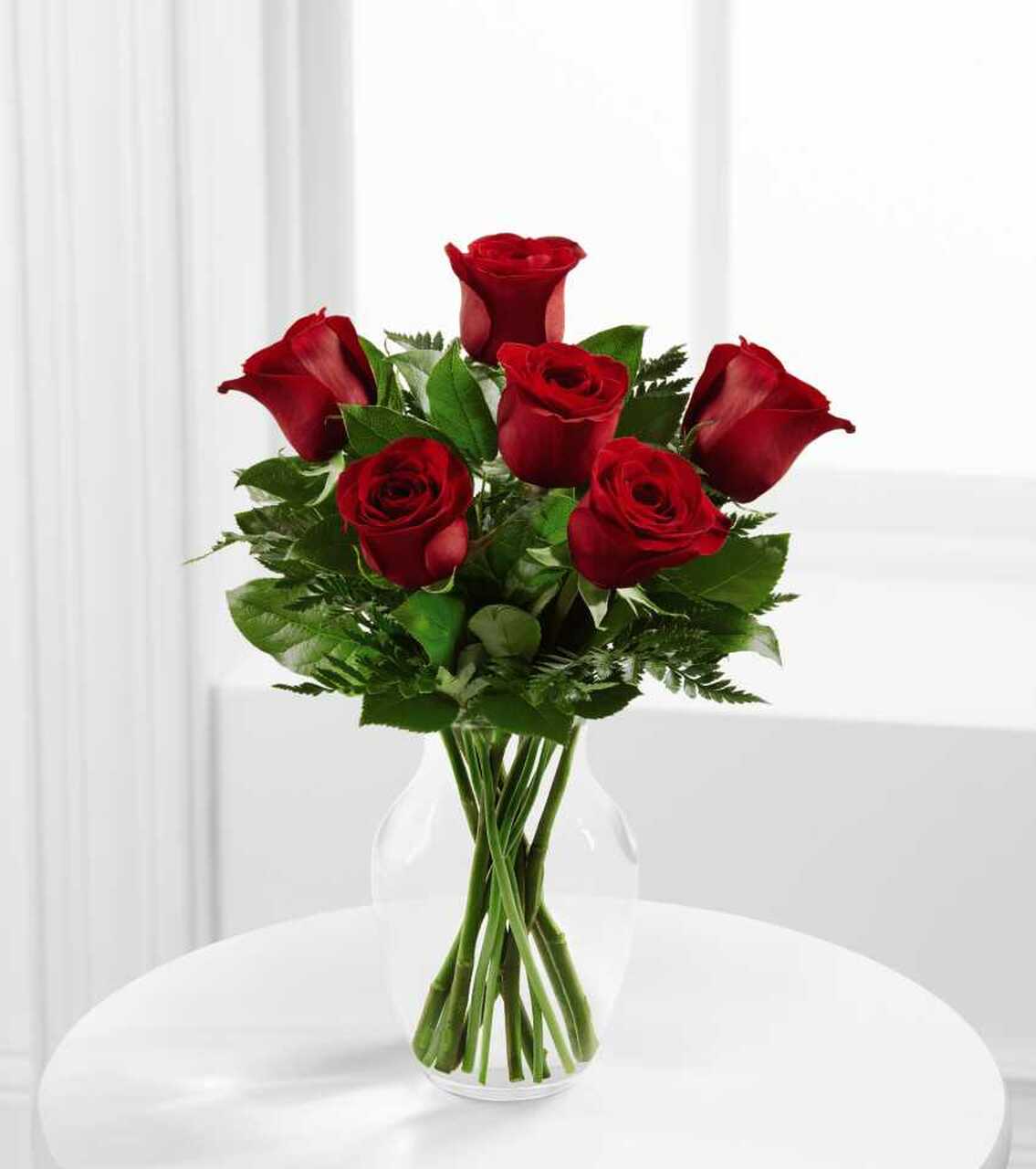 Half Dozen Classic Red Roses in Vase - A half dozen roses in your choice of color, elegantly gathered with lush, captivating greenery and artfully arranged in a timeless glass vase. This classic and enchanting bouquet is the perfect romantic gesture she’ll cherish and remember.