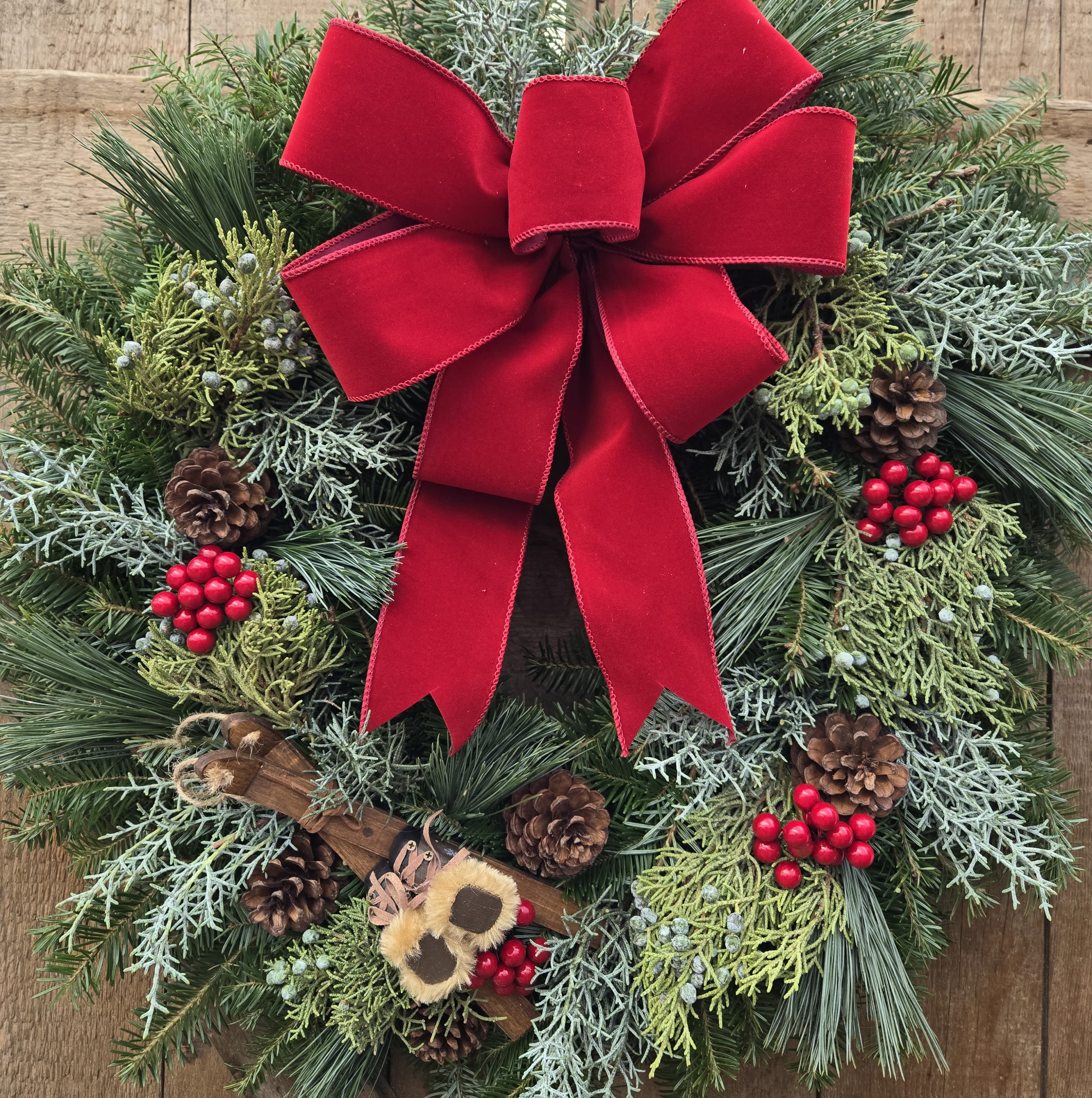 Hit the Slopes Wreath GC-41112 - Beautiful door sized wreath accented with red berries and a skis and boots ornament and finished off with a red bow. This wreath will have you ready for winter and for hitting the slopes!