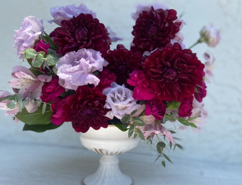 La Dolce Vita  - La Dolce Vita is an artful composition of premium blooms, arranged with the precision and refinement that define April May Flowers. Presented in a classic pedestal compote, this design embodies elegance and couture floral styling. Each petal is placed with intention, creating a sculptural centerpiece that speaks to sophistication.  La Dolce Vita is more than flowers- it is a reminder to live beautifully, love deeply, and surround yourself with elegance.  *PLEASE NOTE: some of these blooms aren’t always in season. If certain blooms aren’t available, we will still maintain overall aesthetic and vibe using equal price point floral varieties.*