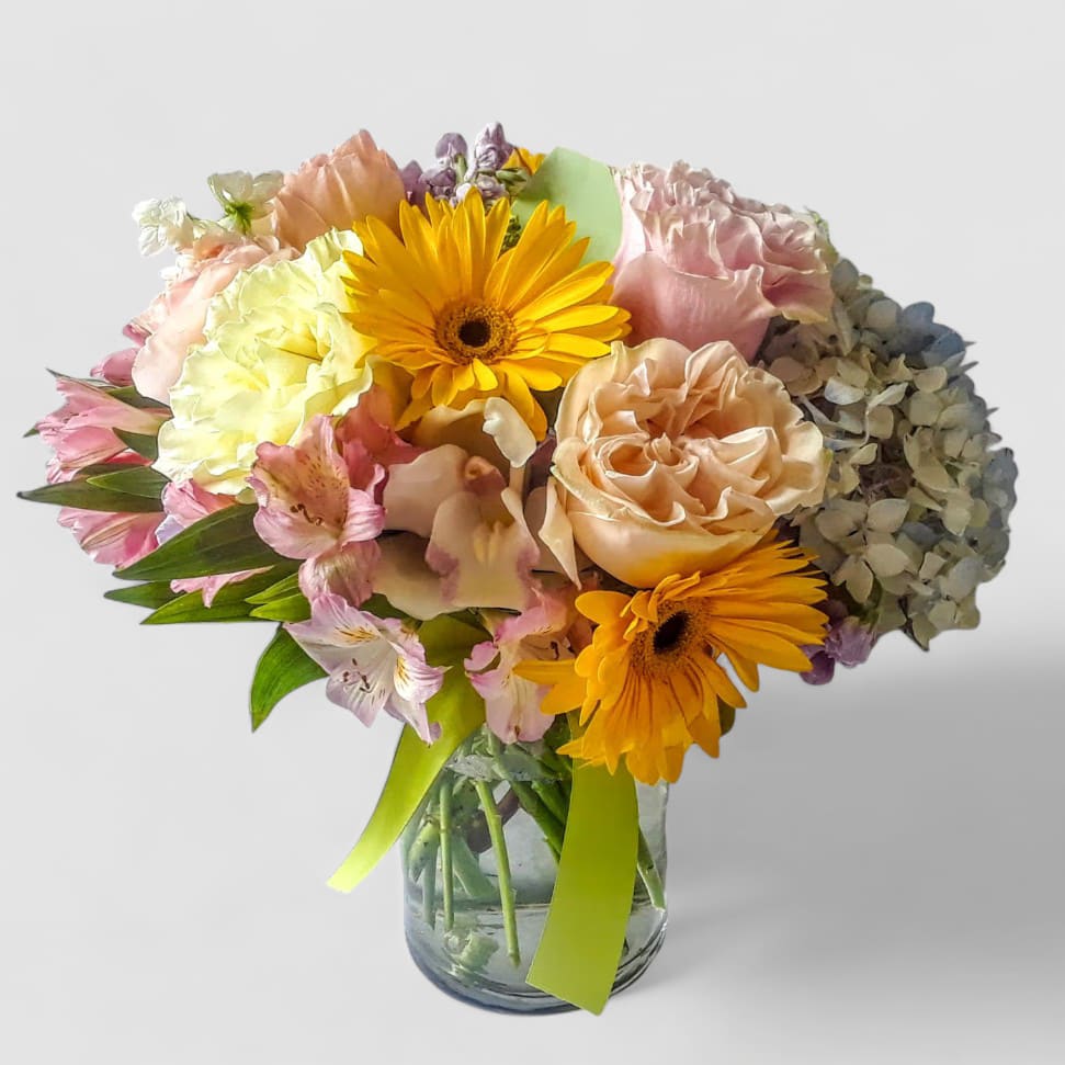 With Condolences Designer's Choice - Roses orchids  and more arranged in a tall modern glass cylinder vase. Perfect to send as a condolences to show them how much you care. All of my bouquets are always made extra special and unique each and every time. Send them your condolences.