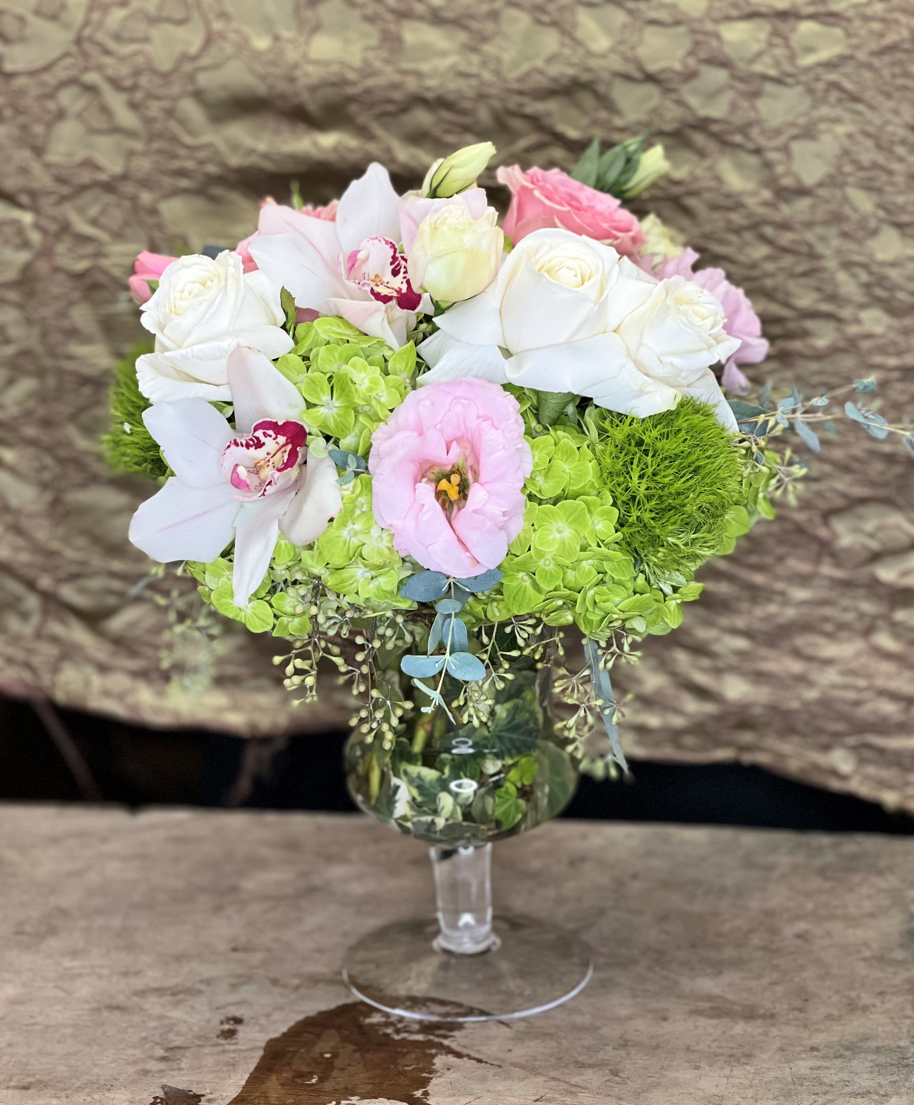 ELEVATE - Elevated glass with Emerald Hydrangea, Roses, Orchid blooms and more flowers creating this &quot;just the right size&quot; bouquet.