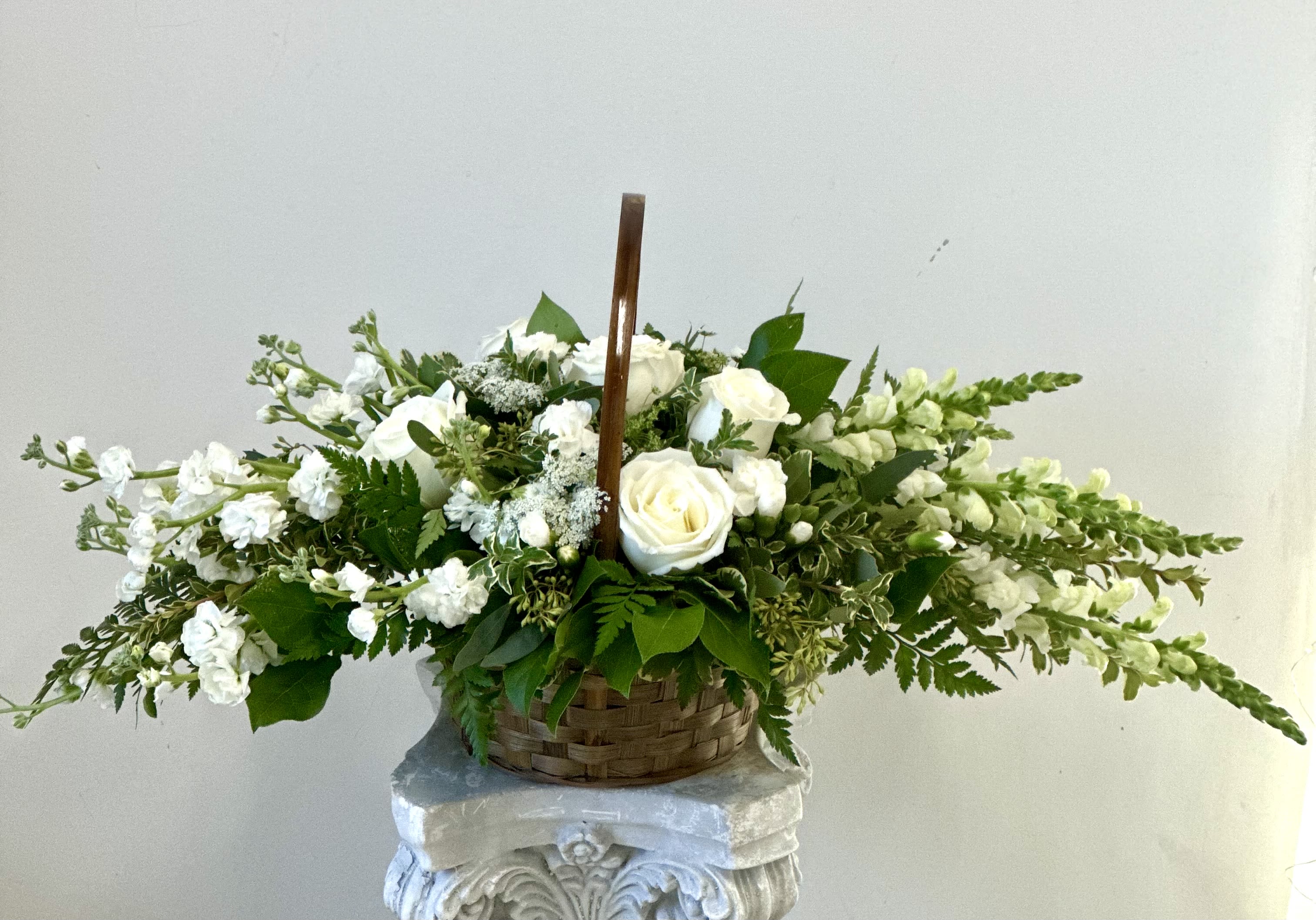Heavenly by Westford Florist Art by Veny - Experience the profound beauty of compassion with the Heavenly Sympathy All Around Basket by Westford Florist Art by Veny. This exquisite arrangement transcends traditional floral offerings, serving as a heartfelt tribute that encapsulates peace and solace during moments of grief. Handcrafted by our skilled florists, each basket features an elegant assortment of all-white flowers—symbolizing purity, innocence, and new beginnings. White roses exude grace, while fragrant lilies bring a sense of tranquility; delicate carnations complete this stunning display. The Heavenly Sympathy Basket is more than just flowers; it's a meaningful gesture designed to express your deepest condolences with warmth and sincerity. Trust us at Westford Florist to deliver this exquisite arrangement with utmost care so that it can offer solace and grace during moments of sorrow. We strive to provide exceptional quality in both our arrangements and services because we understand how important it is for you to express your heartfelt emotions through this floral tribute. Our Heavenly sympathy basket arrangement is a beautiful way to honor the memory of a loved one and offer support during trying times. Let it be a symbol of your heavenly love and affection for those who are grieving. Trust in Westford Florist to create stunning arrangements that convey the deepest condolences with grace and elegance.
