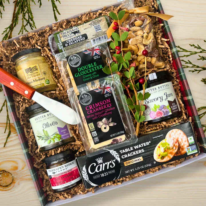 Christmas Charcuterie - From Augusta Gift Baskets, Send your favorite foodie a holiday gift box packed with savory snacks. This impressive assortment is packed with gourmet summer sausage, delicious cheeses, crispy crackers, pitted olives and deluxe salted mixed nuts. It also includes tasty toppings like savory jams and dijon mustard.