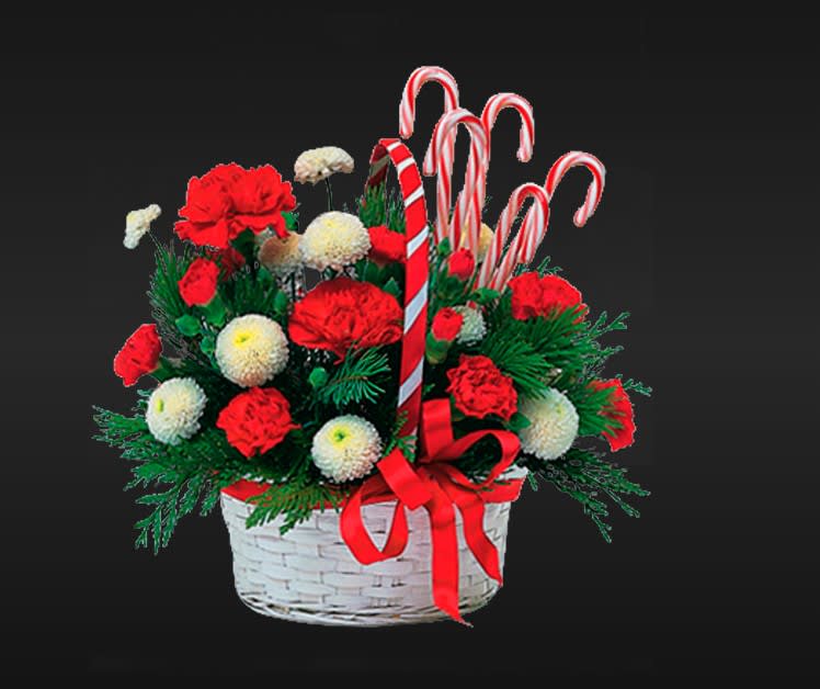 Candy Cane Wishes - A delightful wicker basket is filled with holiday greens and the seasons best blooms. Candy canes are added for a touch of whimsey. Available in 3 sizes.