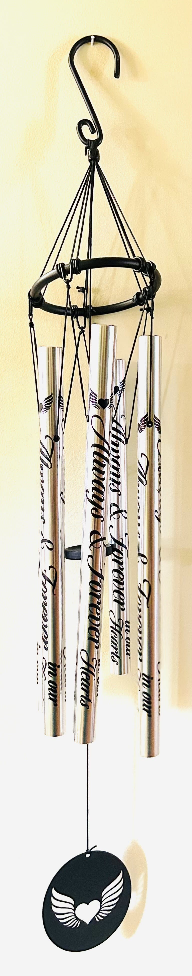 Always &amp; Forever in Our Hearts Wind Chime - Message on Chimes: Always &amp; Forever in Our Hearts&quot; Symbol on Wind Catcher &quot;Angel Wings with heart center&quot; Specifications: • Hand-tuned to provide superior tones and resonance • 2” hook for easy hanging • 37” length from the top of the gathering ring to the bottom of the wind catcher 5&quot; x 37&quot; Height The &quot;Always &amp; Forever in Our Hearts&quot;  Stainless Steel Wind Chime.  If you would like to purchase a Wind Chime Stand for Presentation, please click the Deluxe Price. The Deluxe includes the 15.00 price of the stand.
