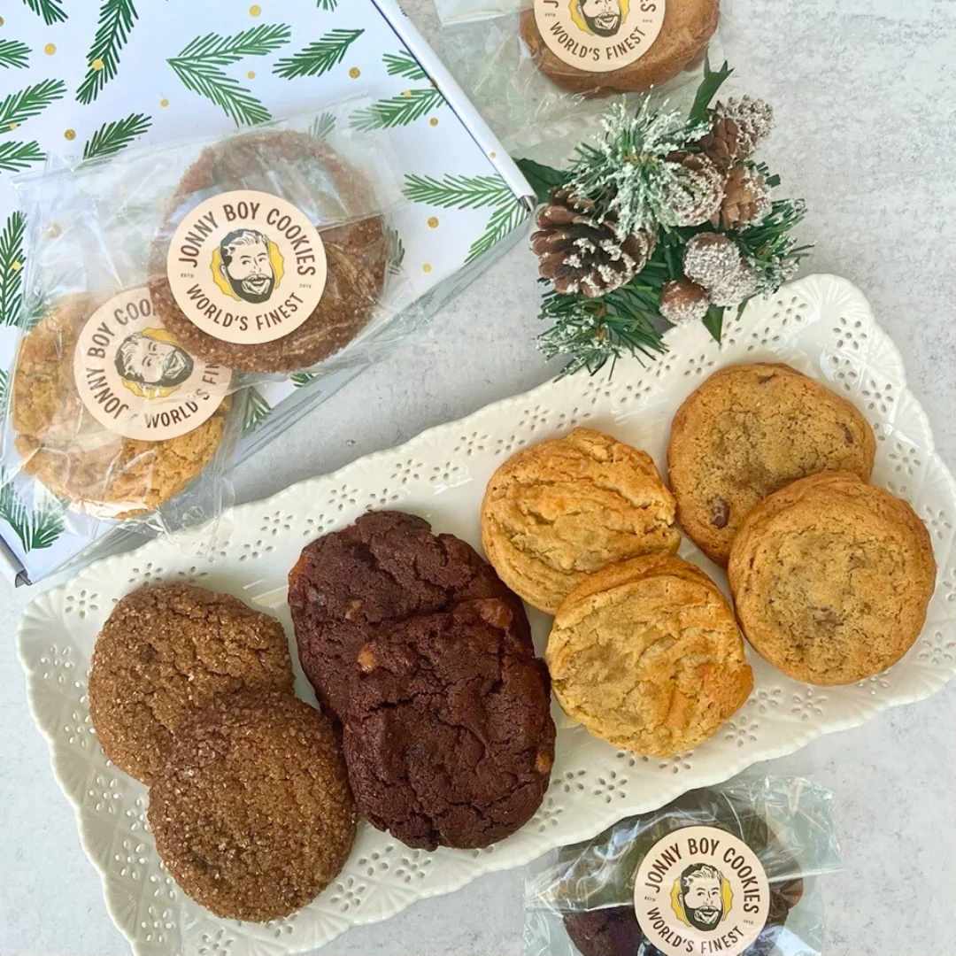 Christmas Cookies  - Celebrate sweet moments this holiday season with a dozen outrageously delicious Jonny Boy Cookies. Hand-crafted with love in Statesboro, GA, each cookie is inspired by family recipes passed down through generations. From the classics to seasonal favorites, there’s something for everyone -- salted caramel brownie, chocolate chip, caramel apple and molasses!