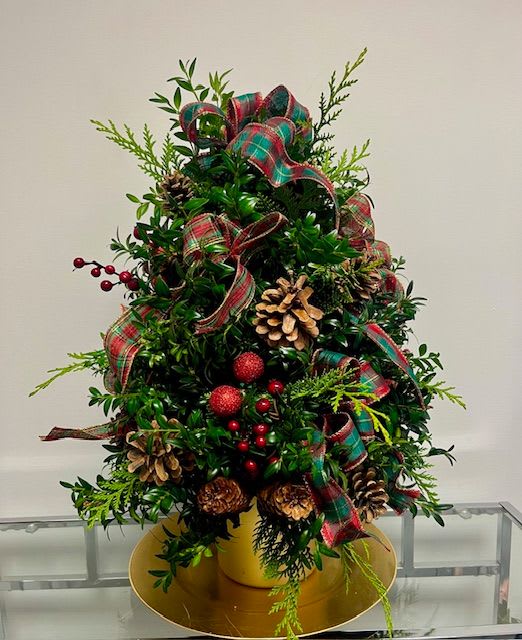 It's a Ralph Lauren Christmas - This grand and lush boxwood tree is accented with white pine and cedar. Plaid ribbon, red berries, and pinecones adorn this classic style tree. Add lights by selecting the DELUXE version below. Add lights and additional trim by selecting the PREMIUM version. 