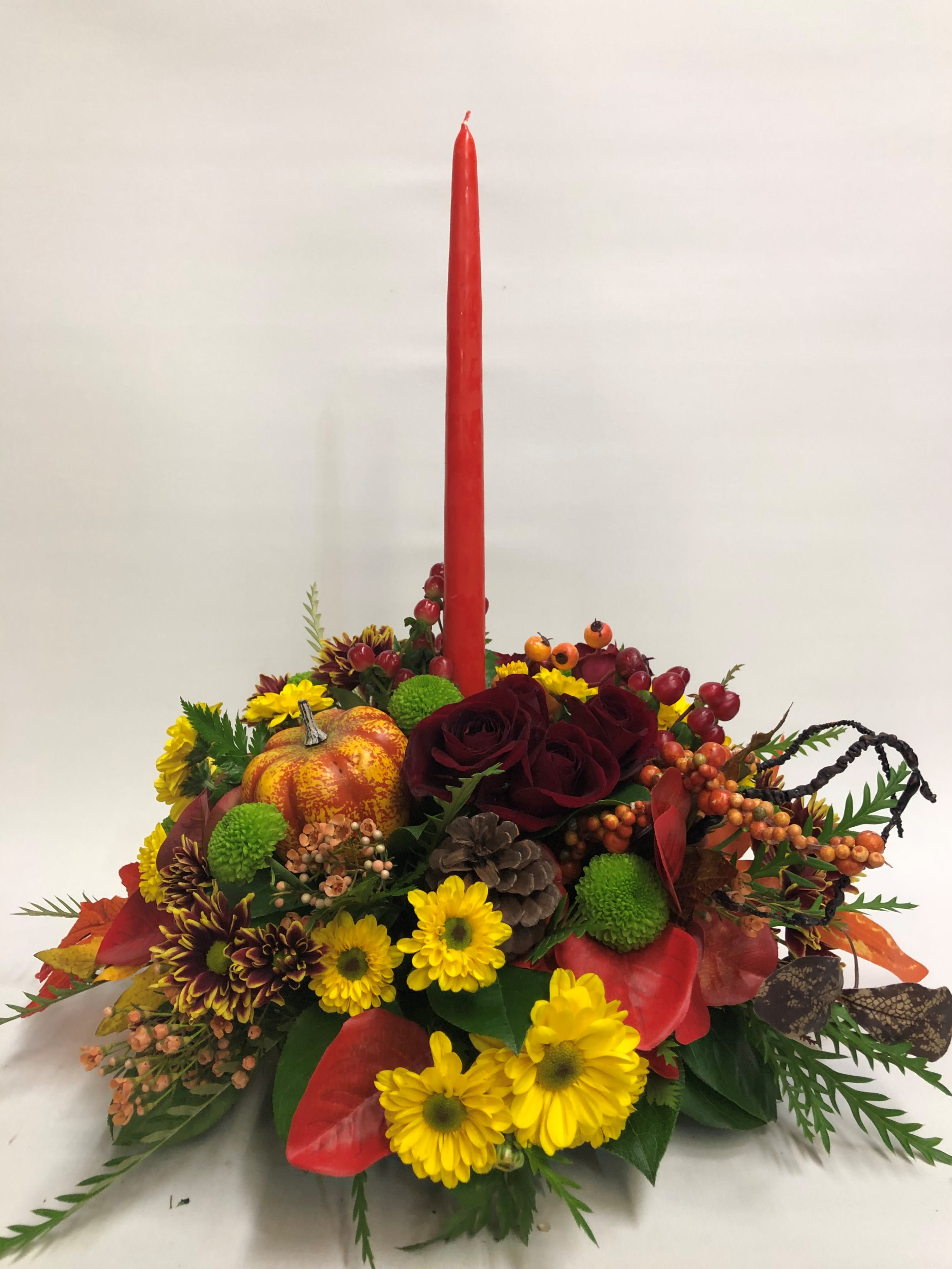Autumn Rose - Let this classic centerpiece light up your table. Filled with a beautiful assorment of fall flowers. Candle color depends on what is available. 