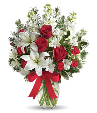 Holly Jolly Vase  - All things are bright with this Elegant all white vase with touch of red roses. Lovely white lillys, white stock, white lisianthus are complimented by natural evergreens. Such a lovely way to start the holiday season. 