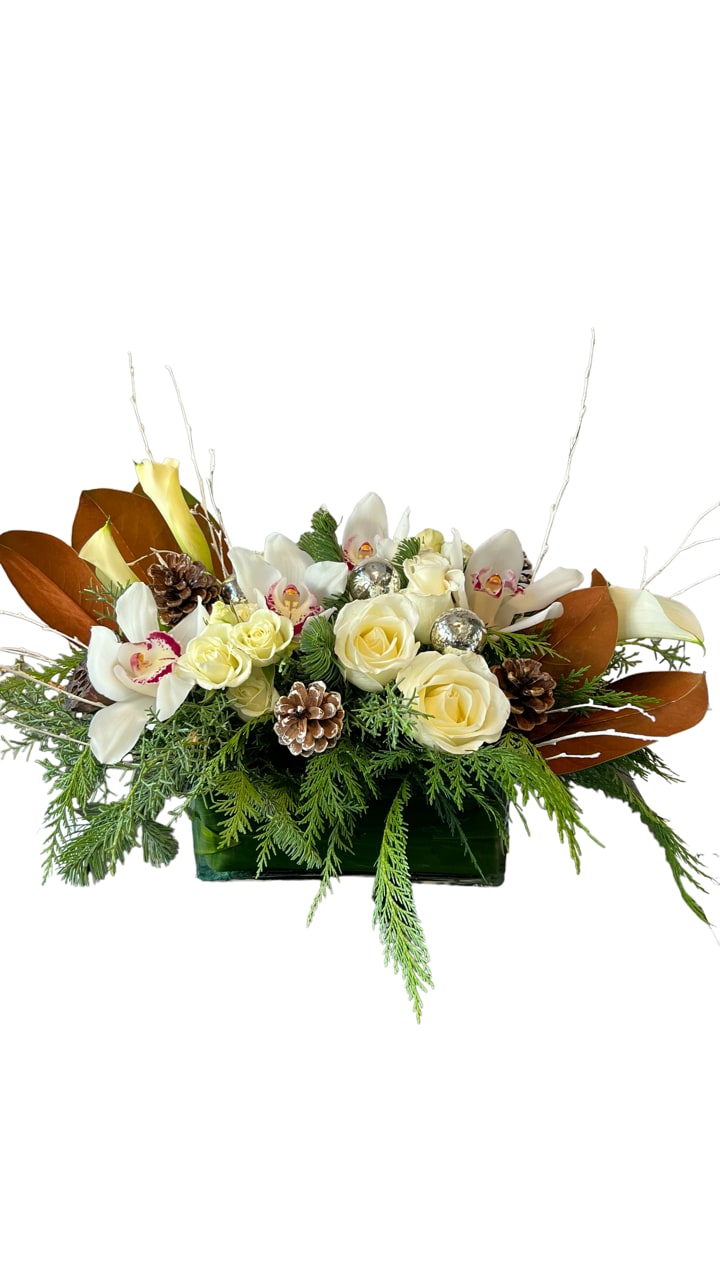 Winter Gift - Cymbidium orchids, roses, spray roses, calla lily, Christmas greens and Christmas decor. Designed in a rectangle glass vase. 