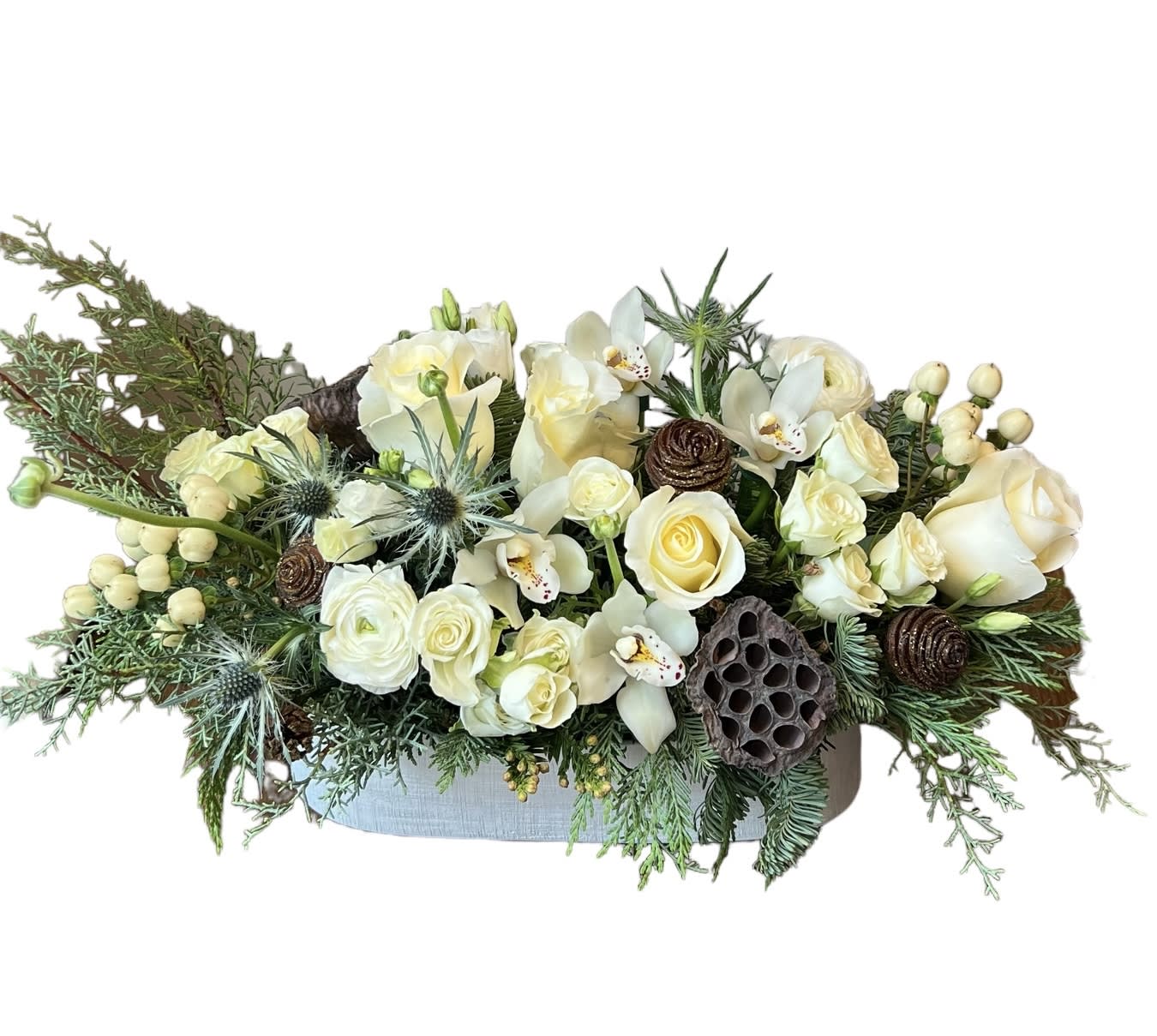 White &amp; Green  Centerpiece  - White roses, white ranunculus, white spray roses, white berries, blue thistle, Christmas greens designed in a long white vase. As shown in photo.