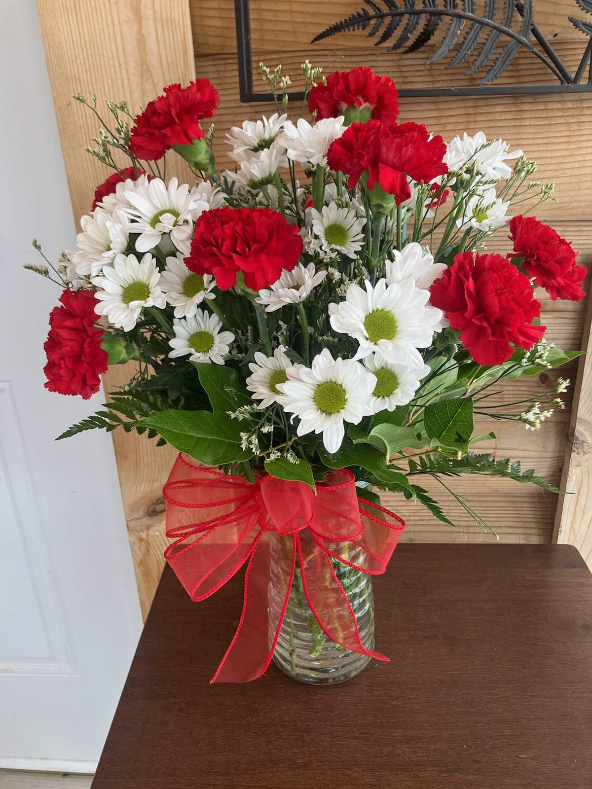 Miss Daisy - Daisies and red Carnations make this a great arrangement for your sweetheart!