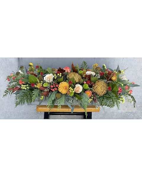 Joyful Thanks - This large centerpiece is going to be gorgeous on any Thanksgiving table. The container is 5 1/2&quot; wide and 2ft Long filled with fall disbuds, dahlia, peach roses, Hypericum berries, mini carnations, pine, seeded eucalyptus, copper beech, Magnolia and Statice  Due to the nature of perishable products, some floral products may require minor substitutions. We'll contact you if drastic substitutions are required. All prices in USD ($)