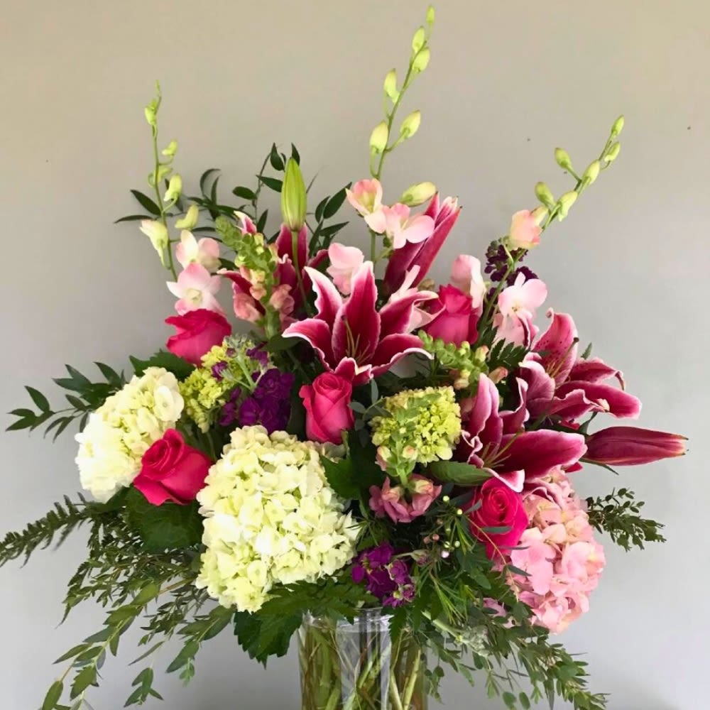 TGI-Flowers  - This elegant vase is filled with a beautiful combination of pink and white flowers, creating a lovely and harmonious display. Perfect as a centerpiece for any room or as a thoughtful gift for a special occasion, this arrangement adds a touch of sophistication and charm to any space. The vibrant colors and delicate blooms are sure to brighten up any environment and bring a sense of joy and beauty to those who admire it.  A unique arrangement hand created by our experienced designers. Please note that every design is custom made and substitution to container and flower types may happen from time to time. Design aspects will always stay the same, but if needed, we will substitute with flowers of equal or greater value to offer you a great floral shopping experience! Our flowers are 100% guaranteed. Please call us with any questions or concerns.