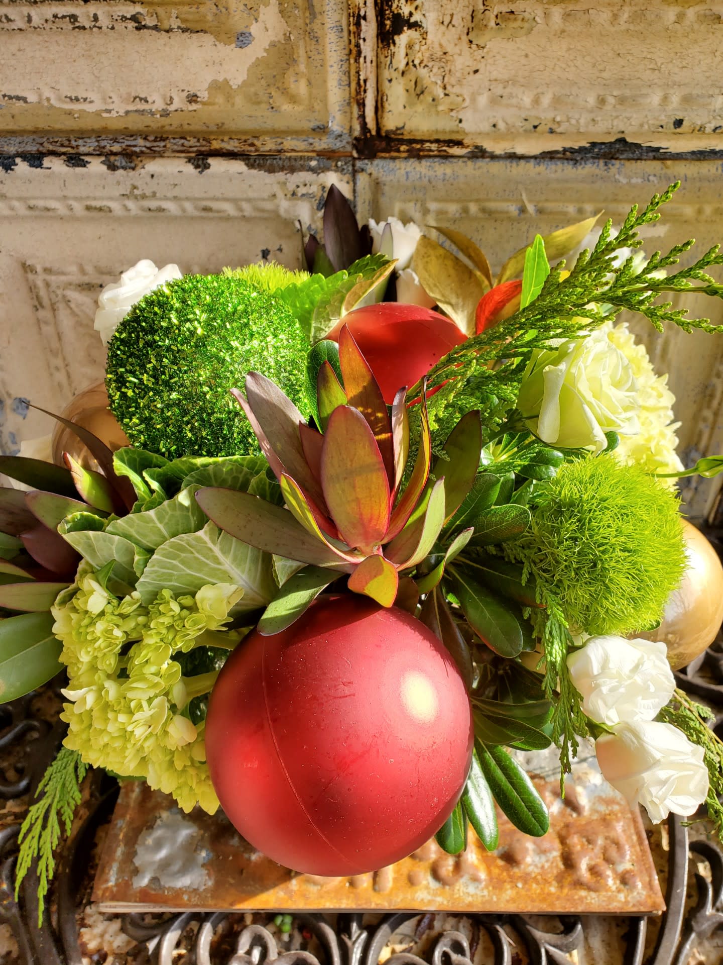 Kathy Griffin - A gorgeous holiday arrangement of roses and spray roses, lilies, cedar, kale, safari sunset, trick dianthus, and assorted Christmas ornaments.