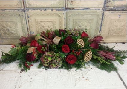 Otis Redding - The perfect holiday centerpiece -- antique hydrangeas, roses, protea, berries, assorted Christmas foliage, gold painted lotus pods, and decorative Christmas ribbon. 