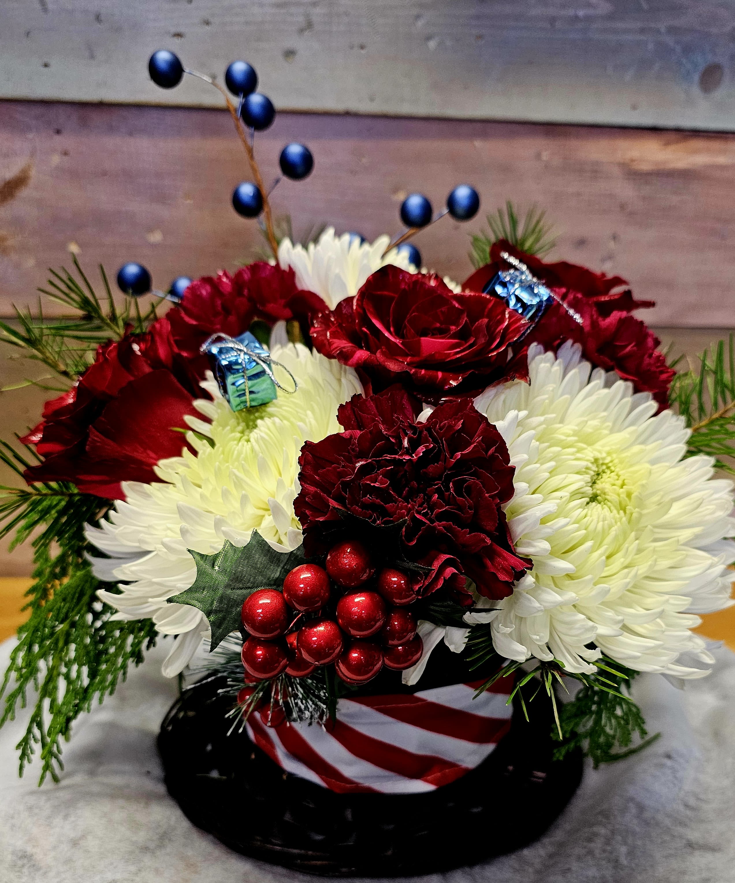 Top of the Town - This top hat is filled with wonderful-smelling Christmas greens and seasonal flowers that best match the holiday season. The hat can be used again for the next holiday season.