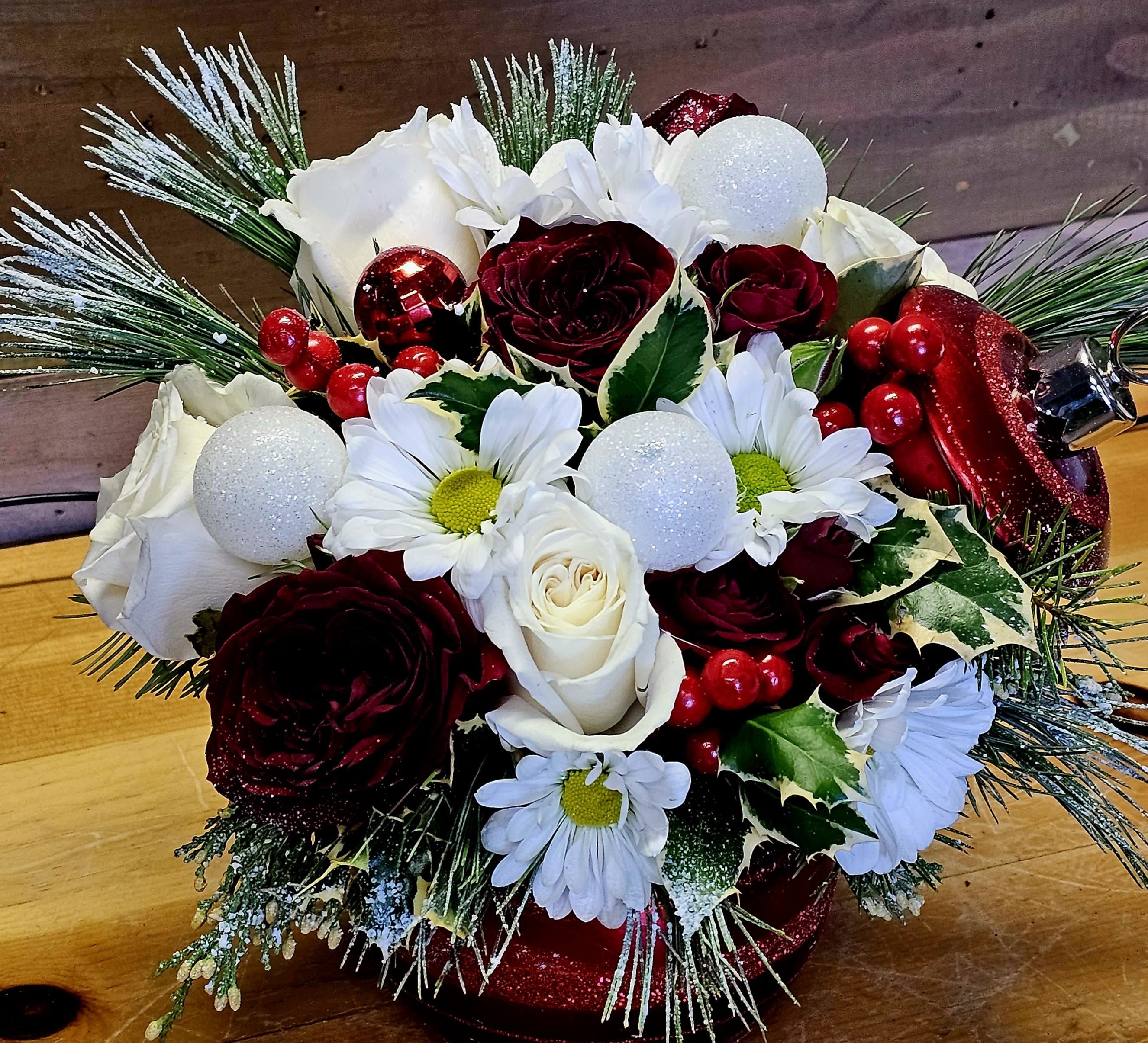 Christmas Ornament arrangement - Enjoy the holidays with a Christmas ornament that will double as a candy or treat bowl after the arrangement is gone. Container will vary from picture. All flowers can change from the picture it varies from what we have in stock. We use the freshest flowers in season. 