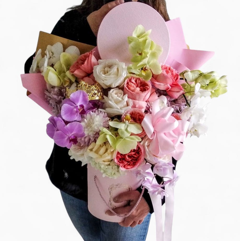 Happy Birthday Rose Hat Box - Send this beautiful large flower bouquet arranged in a pink hat box filled with blush roses violet orchids, vanilla garden roses and so much more adorned with beautiful ribbon.  Stunning and impressive to show her how much you love her. All fresh flower bouquets that I design are made unique different and extra special each and every time. Please visit my beautiful gallery to see my latest designs that I have created for my online customers. Send them happiness today.