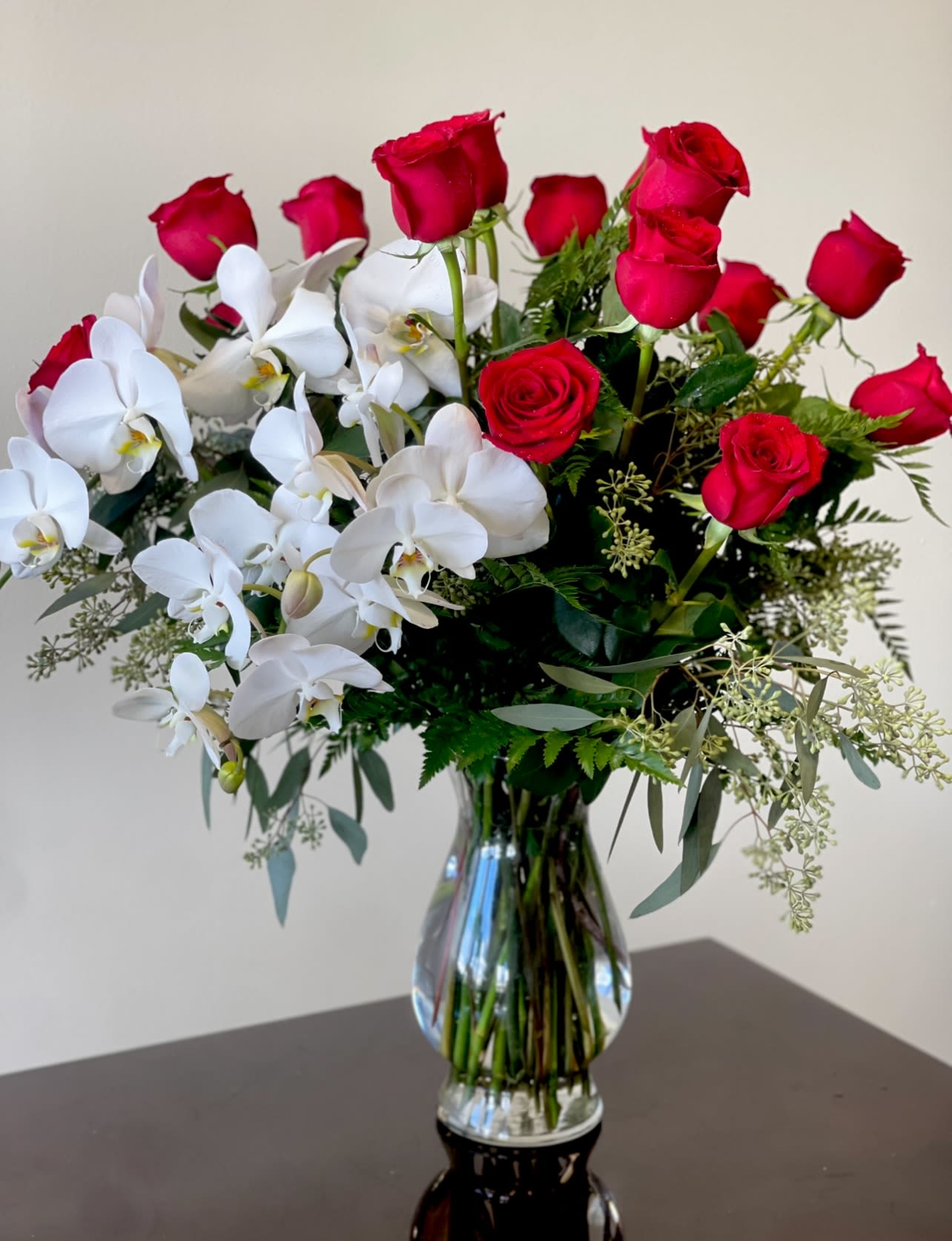 Belle Fleur  -   Your timeless arrangement of 18 roses with 2 stems of phalaenopsis orchids.   Colors can be customized depending on availability. Please call. 