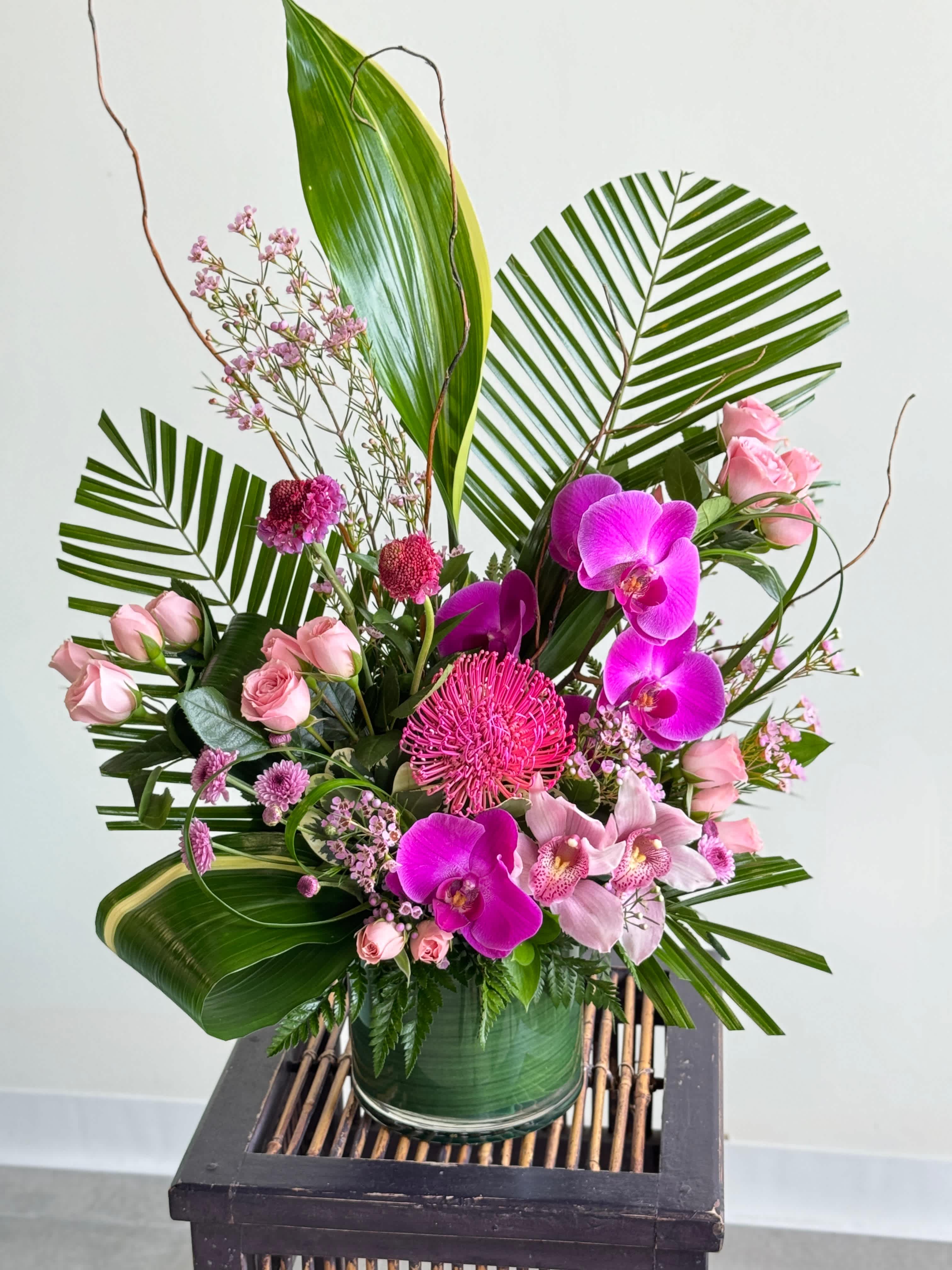 Zen Whisper  - A gorgeous arrangement of tropical stems. Colors are customizable. Please call in or add specifics in notes. 