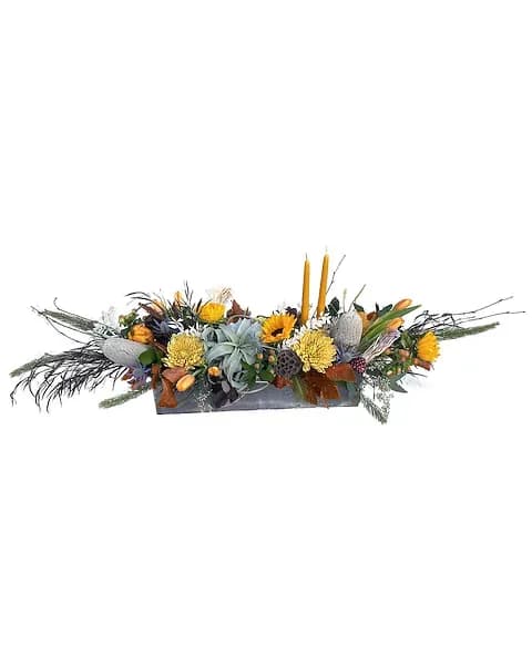 Large Modern Centerpiece - This 20 inch box is packed full of Fall colors. An Air plant is surrounded with sunflowers, mums, tulips, thistle, mixed greens and dried elements.  Due to the nature of perishable products, some floral products may require minor substitutions. We'll contact you if drastic substitutions are required.