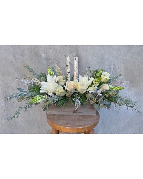  Winters Glow  - This centerpiece is a wood box with a set of birch candles Dubium, Rose lilies, Roses, Silver thistle, Christmas Greens and Gold leaves.  Due to the nature of perishable products, some floral products may require minor substitutions. We'll contact you if drastic substitutions are required. All prices in USD ($)  Standard  HF-F179