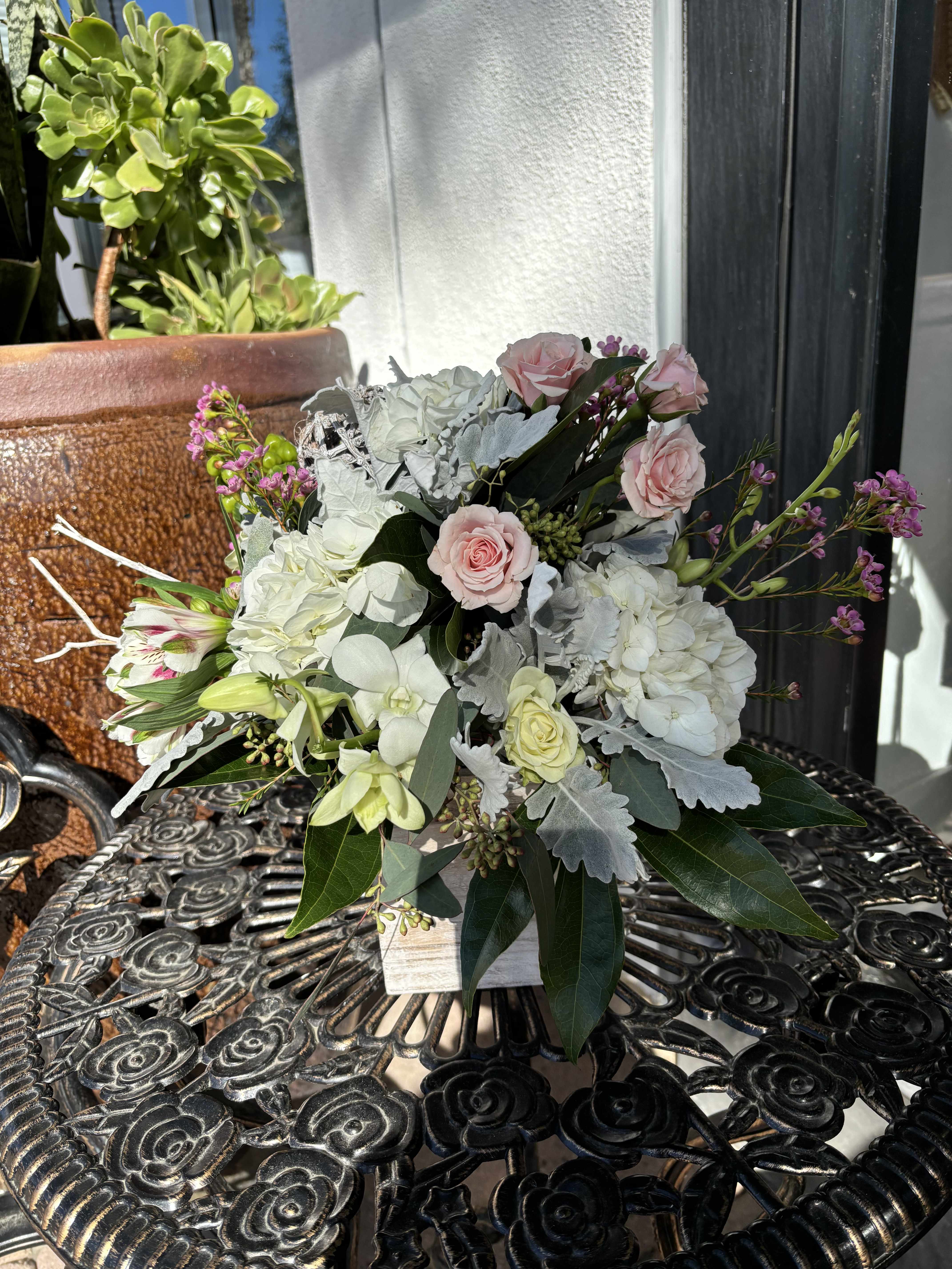 Peace in a Box - Mixed florals of white, soft pink and lavender flowers. Paired with dried decorative sticks in a wooden box. 