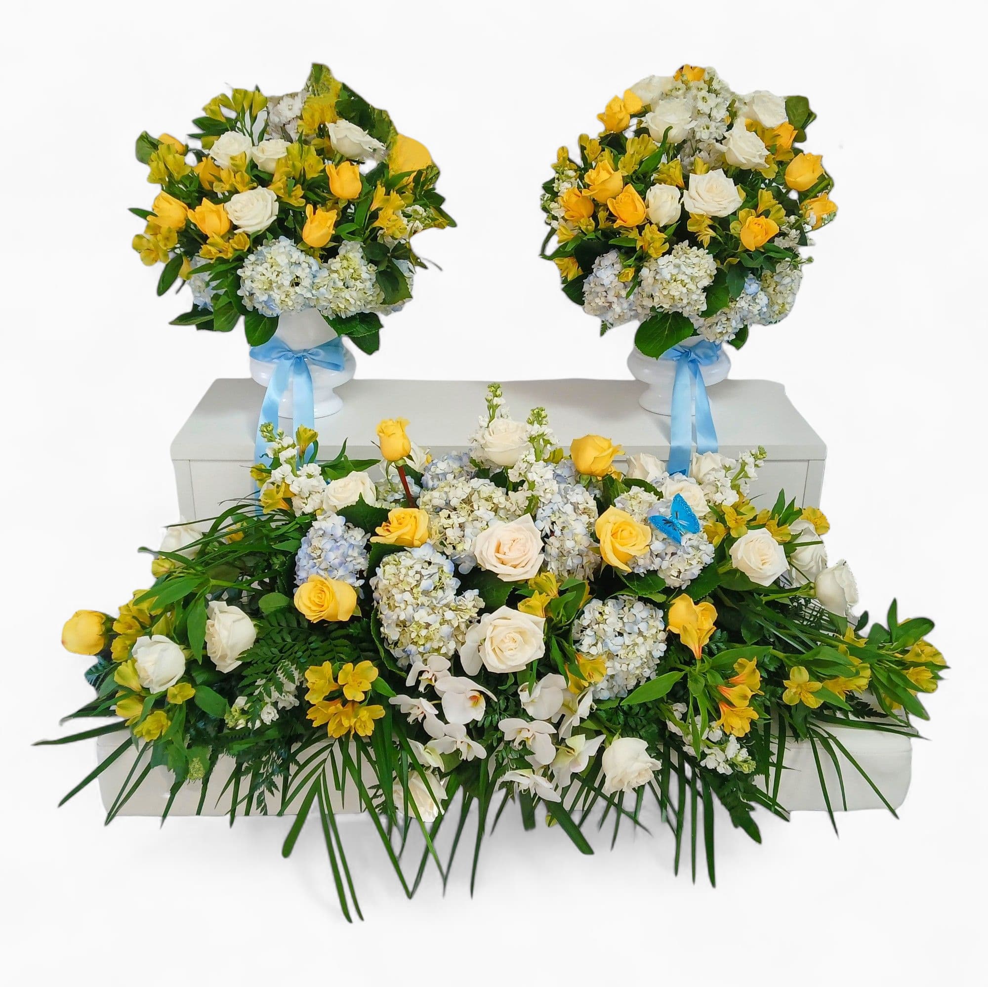 Full Sympathy 3 Piece Tribute Flowers - Please call for color choice on this beautiful 3 piece set. Full sympathy flowers includes the full casket spray filled with premium roses, lush hydrangeas, and heavenly white orchids. Matching included two tall flower arrangements for each side of the spray complete the set. All of my work is made from the heart using only the finest blooms for your loved one's service.