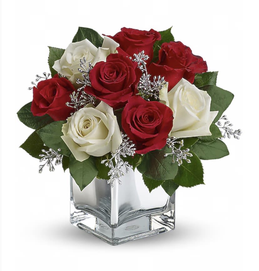 Snow Night - The perfect Christmas hostess gift, this exciting bouquet of red and white roses in a dazzling  cube is guaranteed to make spirits brighter. Simple, stylish, affordable ¬- better order one for yourself as well.  The delightful holiday bouquet features red roses and white roses accented with assorted greenery.