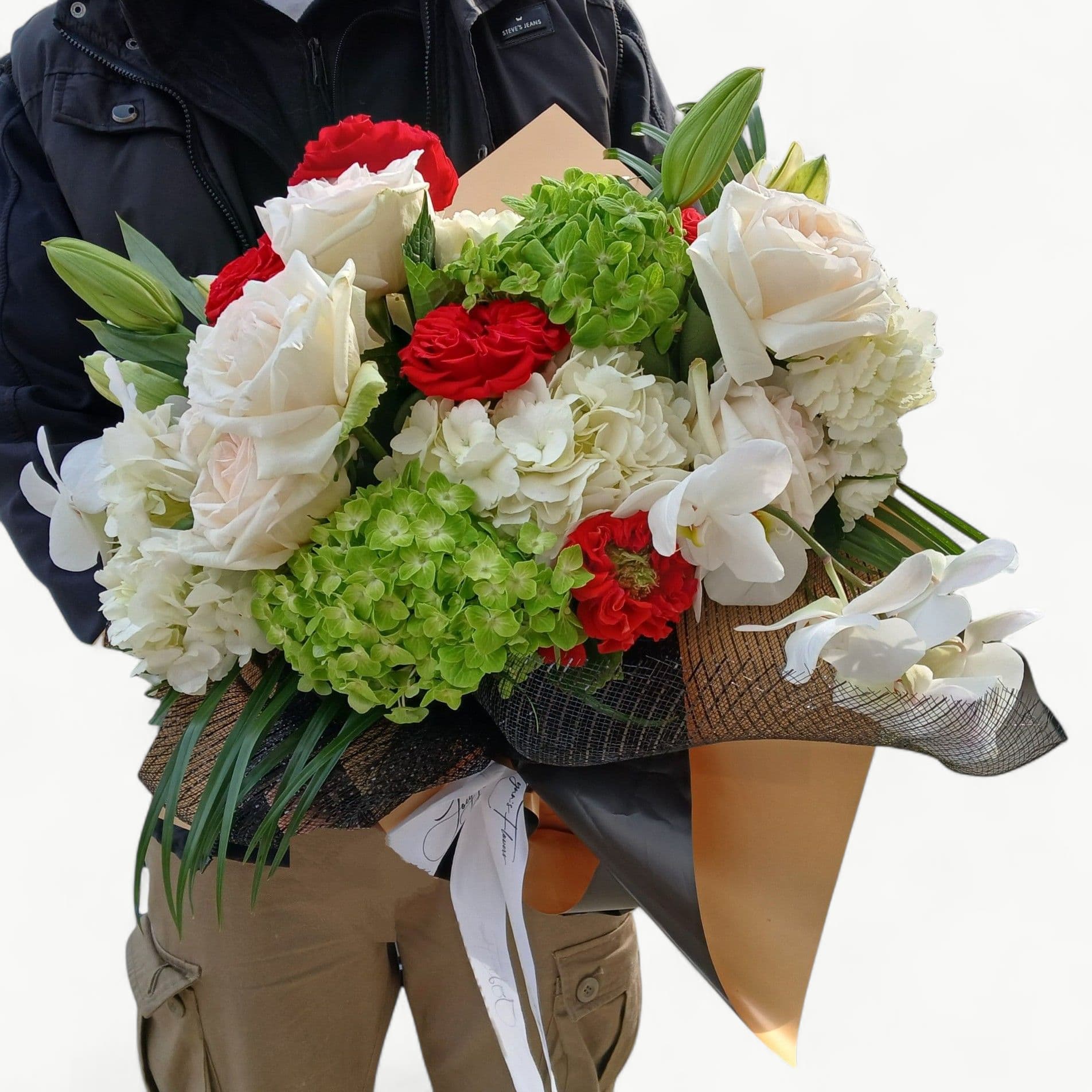 From My Heart To Yours Luxe Bouquet - A luxurious bouquet wrapped in my signature style in the palette of vanilla, citrus and red. Beautiful red premium roses, abundant hydrangeas in vanilla and citrus, and my signature blossoms; white orchids. Perfect to send from the heart.