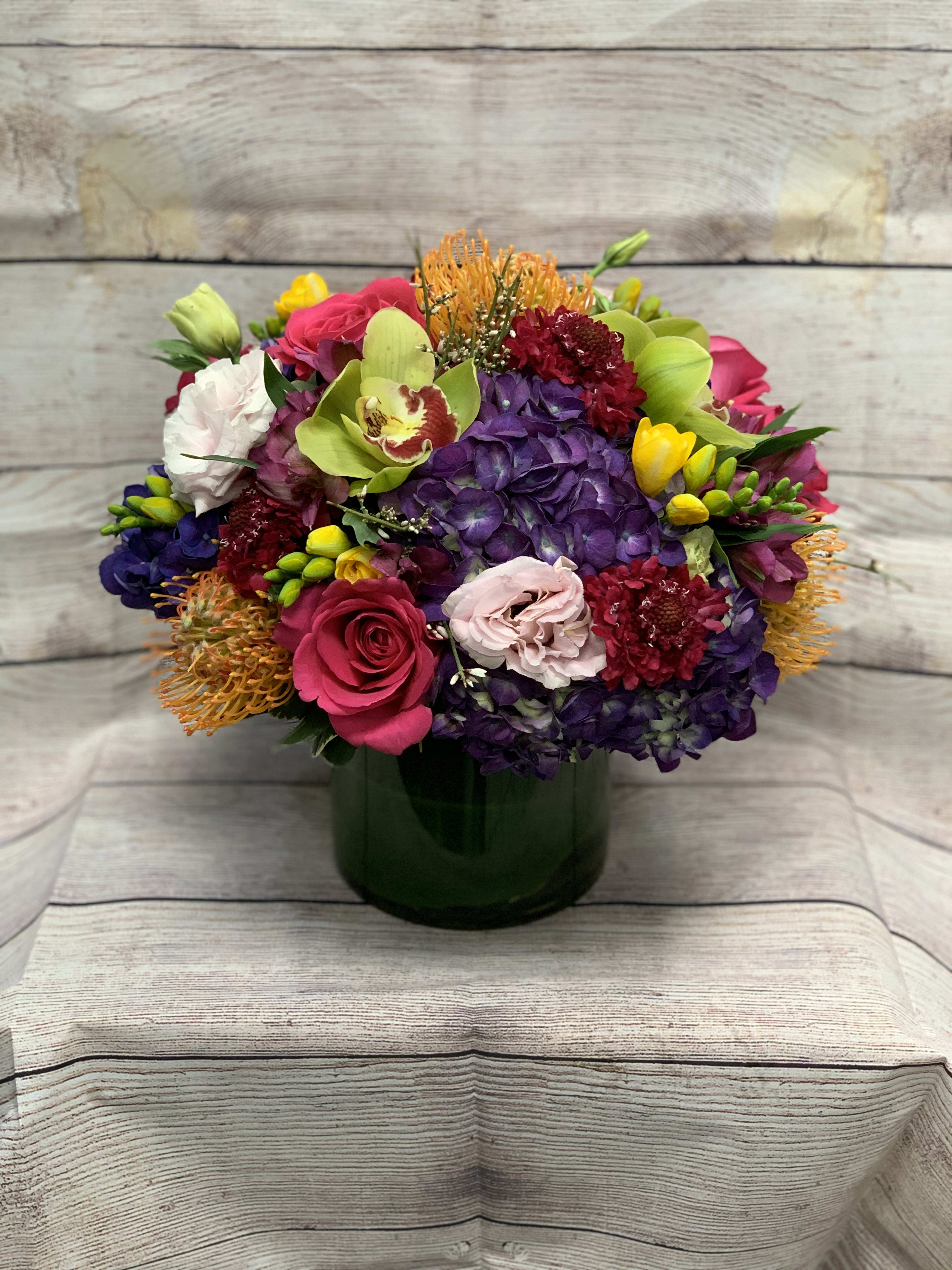 Gems and Jewels - A beautiful arrangement full of deep jewel and gem tones. Perfect for adding a little bit of luxury to your next party.  NOTE: The arrangement pictured is the $200 deluxe upgrade. 