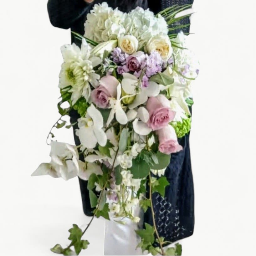 Cascade Wedding Luxe Bouquet - An ultra feminine cascade style luxe bridal bouquet designed with a soft palette of whites lavenders and pinks. Very long and elegant showcasing premium roses, hydrangeas and orchids. Please call for color choices. 