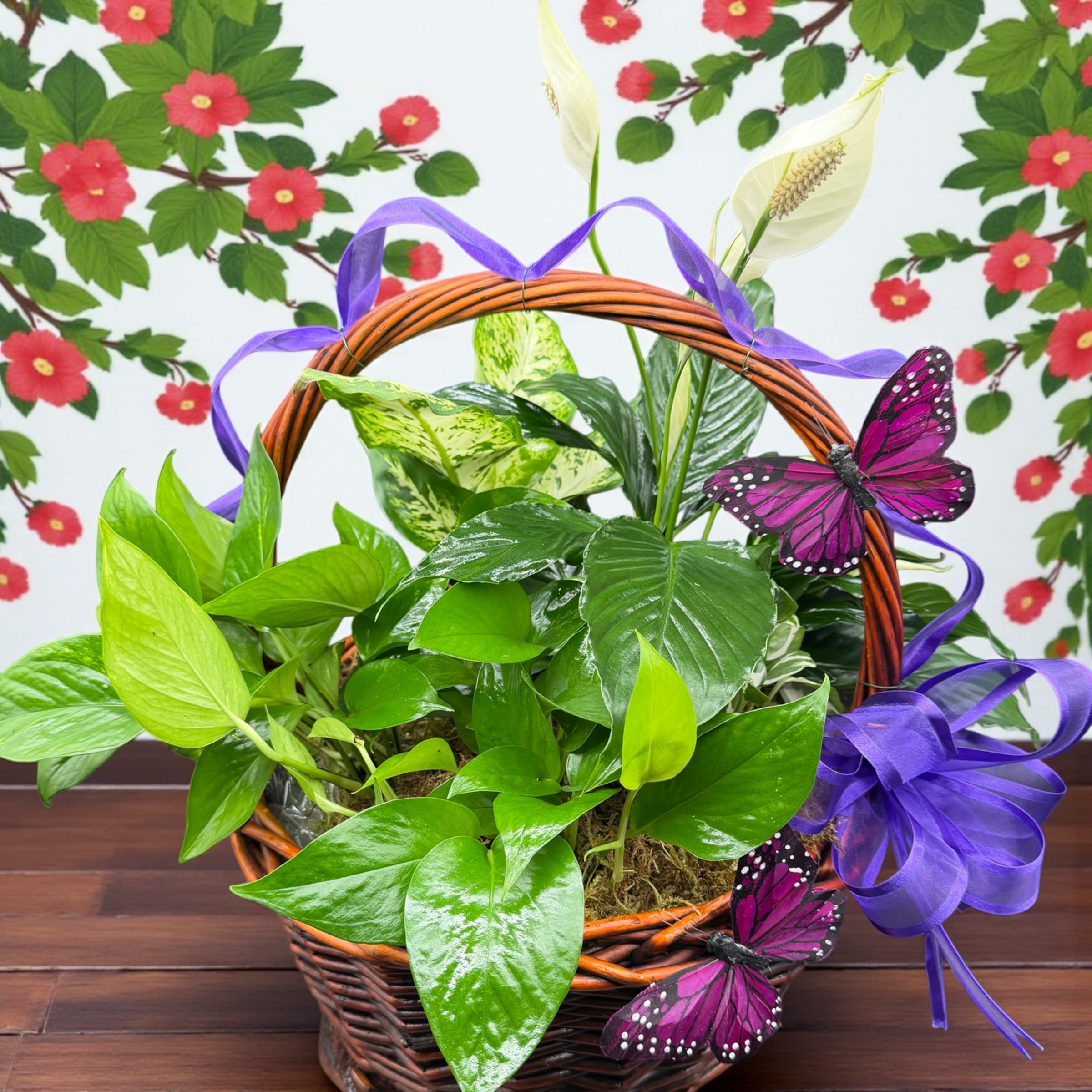 Beauty Basket - A lush garden basket filled with vibrant green plants, accented with elegant peace lilies and delicate purple butterflies. Finished with a soft lavender bow, this piece brings a touch of tranquility and natural beauty to any space. Perfect as a thoughtful gift or a peaceful addition to your home.”