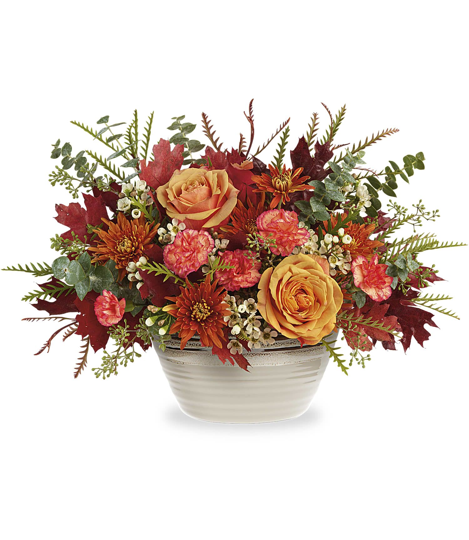 Rustic Harvest Centerpiece - Fresh from the fall countryside, this orange rose centerpiece--arranged in a stunning stoneware bowl with reactive glaze--brings rustic autumnal beauty to any occasion. This bouquet features light orange roses, miniature orange carnations, bronze cushion spray chrysanthemums, white waxflower, spiral eucalyptus and grevillea accented with preserved oak leaves. Delivered in a Rustic Harvest Bowl.   Due to the nature of perishable products, some floral products may require minor substitutions. We'll contact you if drastic substitutions are required.