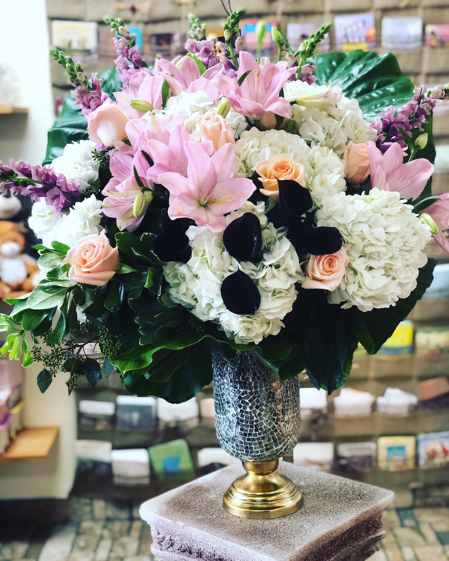 Blushing Love - This blushing beauty of perfectly pink lilies, coral roses, snow white hydrangea, purple snapdragons and calla lilies with lavish tropical greens will make her feel like a queen she is. Perfect for any occasion. *Vase may vary
