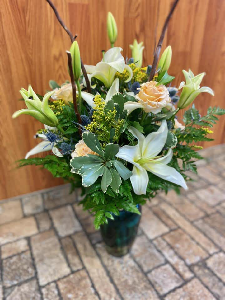 Your'e a Peach - A grand gesture featuring sweet pastel peach and white tones with showstopping lilies, roses and curly willow. Just to let you know, flowers and vases may vary but we do our best to match the arrangement shown.  