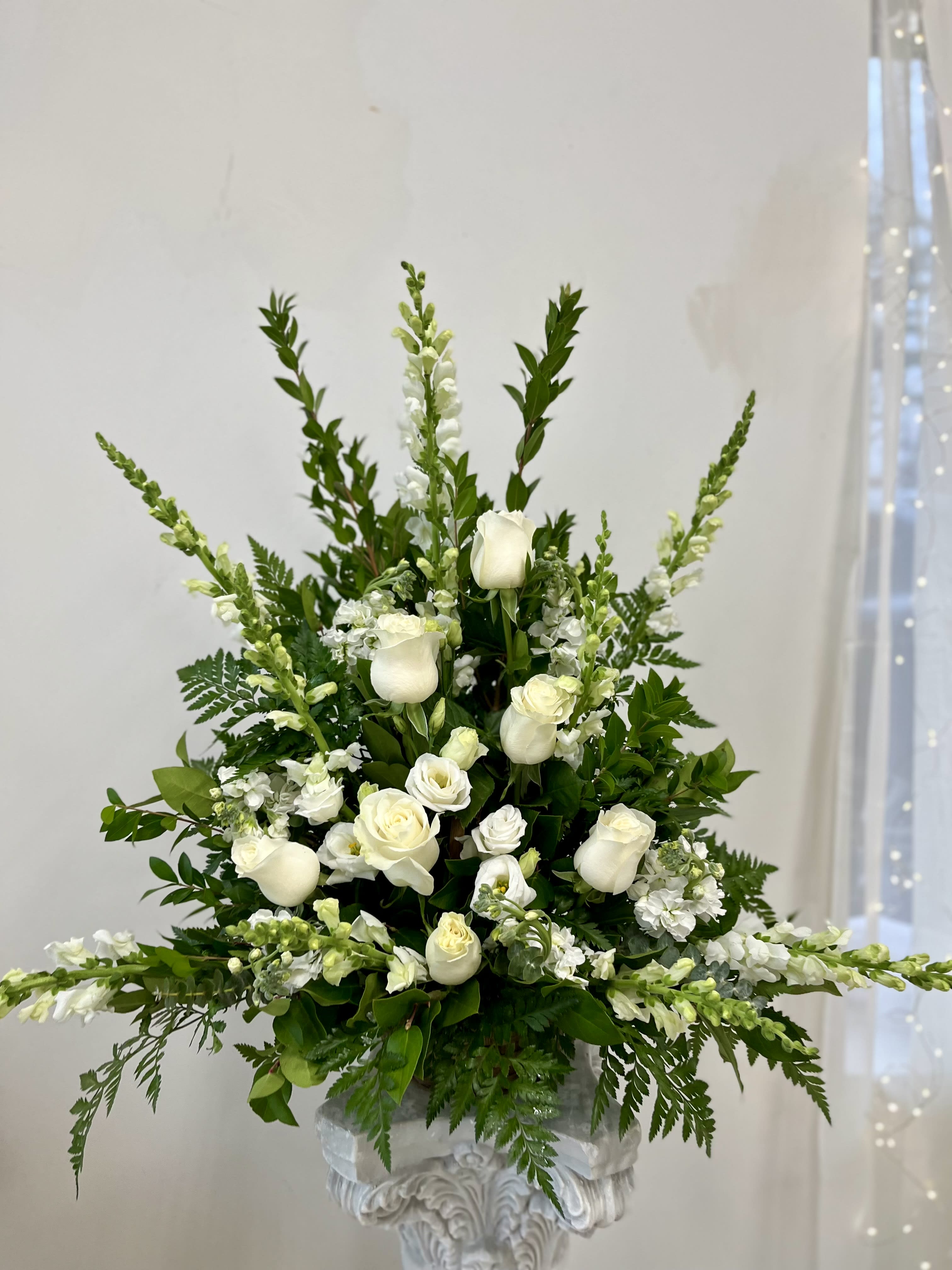 Peaceful white by Westford Florist Art by Veny - During moments of grief, finding the right way to convey your sentiments can be challenging. The Peaceful White One-Sided Basket Sympathy Arrangement by Westford Florist Art by Veny offers a gentle and elegant expression of condolences, thoughtfully designed to provide comfort and solace. This exquisite arrangement features serene white blooms that embody purity and peace, creating a stunning tribute for honoring the life of a cherished friend or loved one. Each flower is carefully selected to evoke feelings of love and remembrance, making it a heartfelt gesture during difficult times. Express your deepest sympathies with this beautiful symbol of compassion and support. At Westford Florist Art by Veny, we understand the healing power that flowers possess. That's why our skilled florists carefully hand-pick each bloom for its quality and freshness to ensure that they convey your sincerest condolences effectively. Our ultimate goal is to provide comfort and solace through these difficult moments with our floral arrangements. Honor your loved ones with this timeless expression of sympathy – the Peaceful White Basket Sympathy Arrangement by Westford Florist Art by Veny. Let us help you pay tribute to their beautiful life with this unforgettable floral display. Place your order today and let us help you navigate through these tough times with grace and elegance.