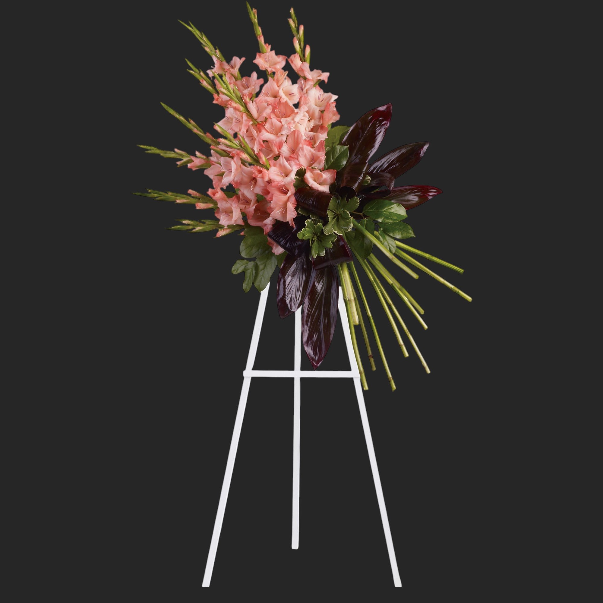 Elegant Tribute  - Beautiful coral gladioli are arranged with pittosporum, salal and red ti leaves to create a spray of flowers that delivers beauty and strength. Approximately 32&quot; W x 37&quot; H. T246-1A