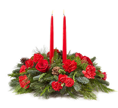 Holiday Classics Centerpiece - roudly presents the Better Homes and Gardens Holiday Classics Centerpiece. Drawing from the rich traditions of holiday décor, this festive centerpiece is set to lend its seasonal beauty to your holiday celebrations. Bright red roses carnations and mini carnations are arranged amongst an assortment of holiday greens, accented with natural pinecones, and a designer red and green striped ribbon. Encircling 2 red taper candles, this lovely centerpiece will bring warmth and Christmas charm to your holiday gatherings with each graceful bloom.