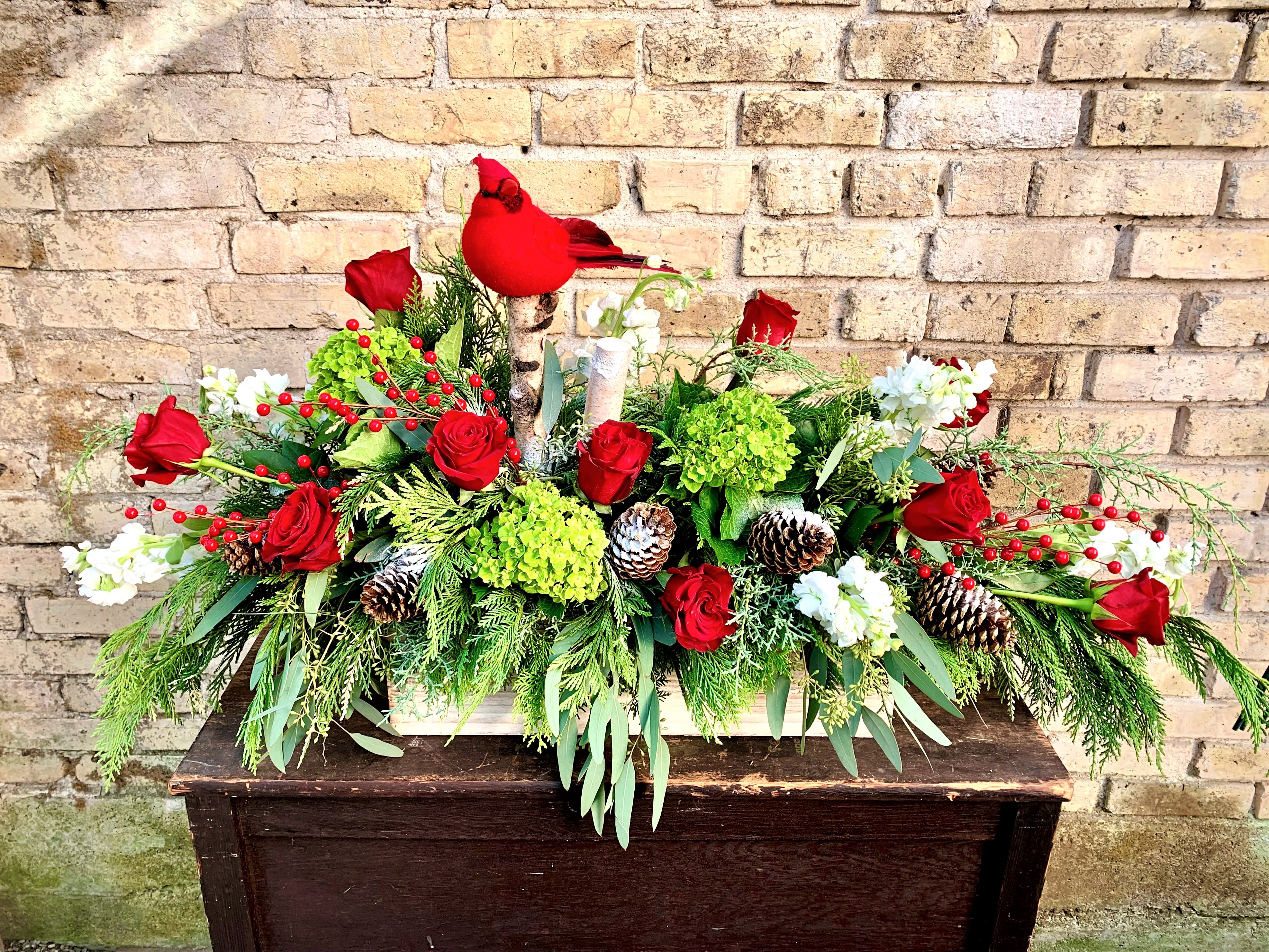 Christmas Wishes - A Beautiful Fresh Arrangement Filled With Holiday Greens, Pine Cones, Birch Logs and Topped Off With a Red Cardinal. Arrangement is Three Sided and is Approximately 36&quot; Long.                                                                                                                                                                                                                                                                                                                                                                                                                                                                                                                                                                                                                                                                                                                                                                                                                                                                   