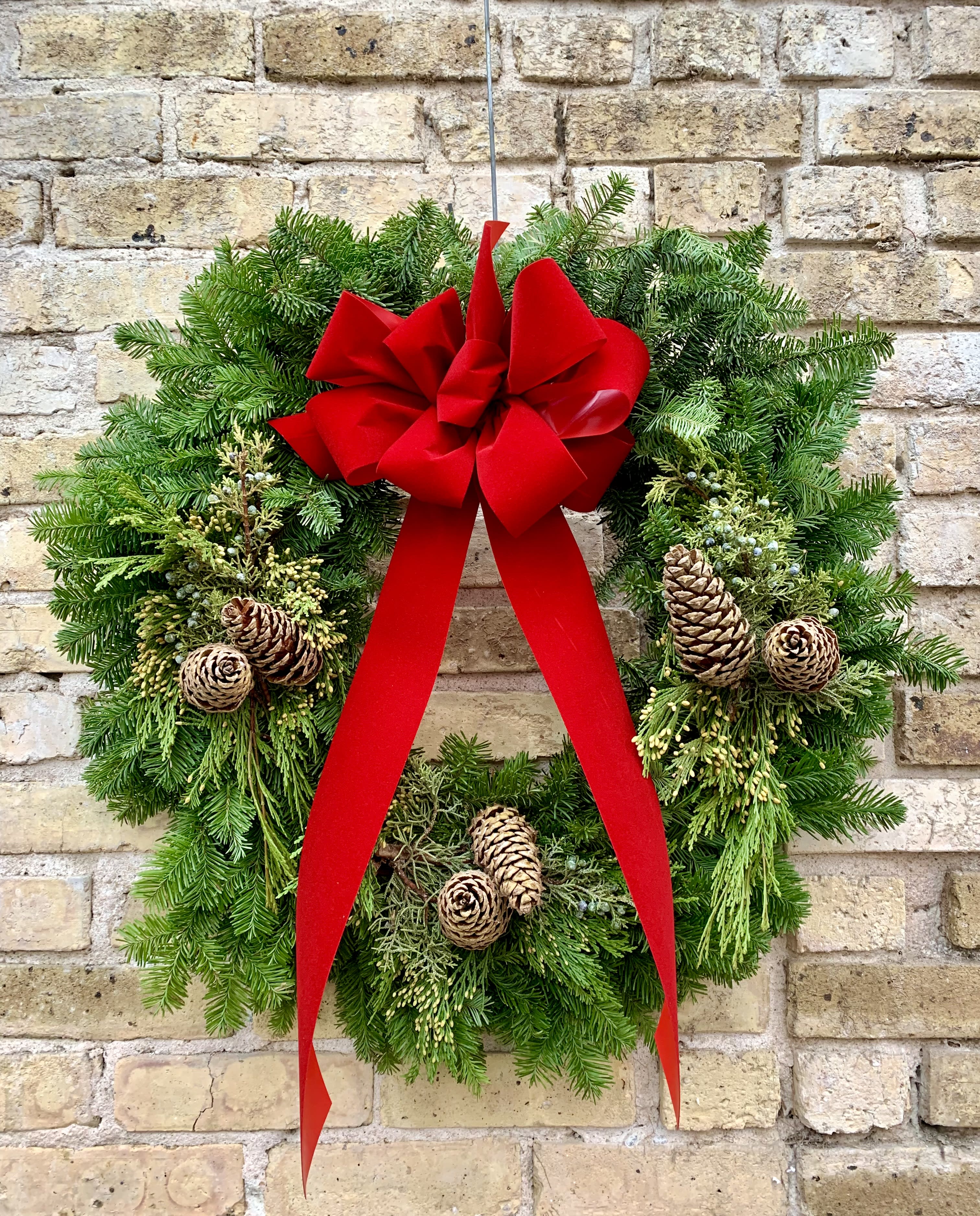 Evergreen Delight - A Fresh Mixed Evergreen Wreath Made With Noble Fir, Incense Cedar, Blue Berried Juniper, Pine Cones and  Topped Off With A Handmade Holiday Red Velvet Bow.