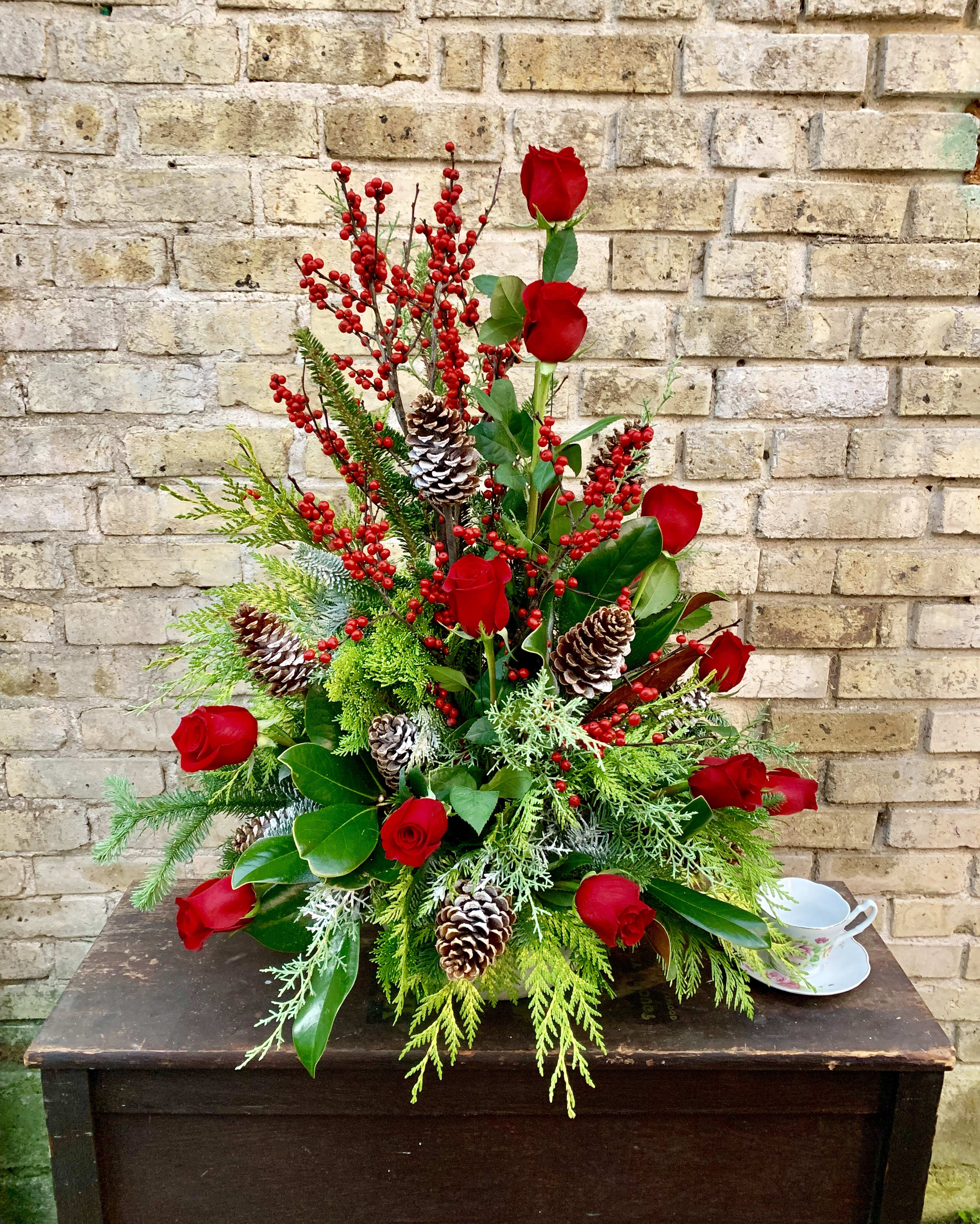 Holiday Cheer - A Lovely Holiday Arrangement With An Assortment Of Fresh Evergreens, Roses, Magnolia, Pine Cones And Winterberry. 