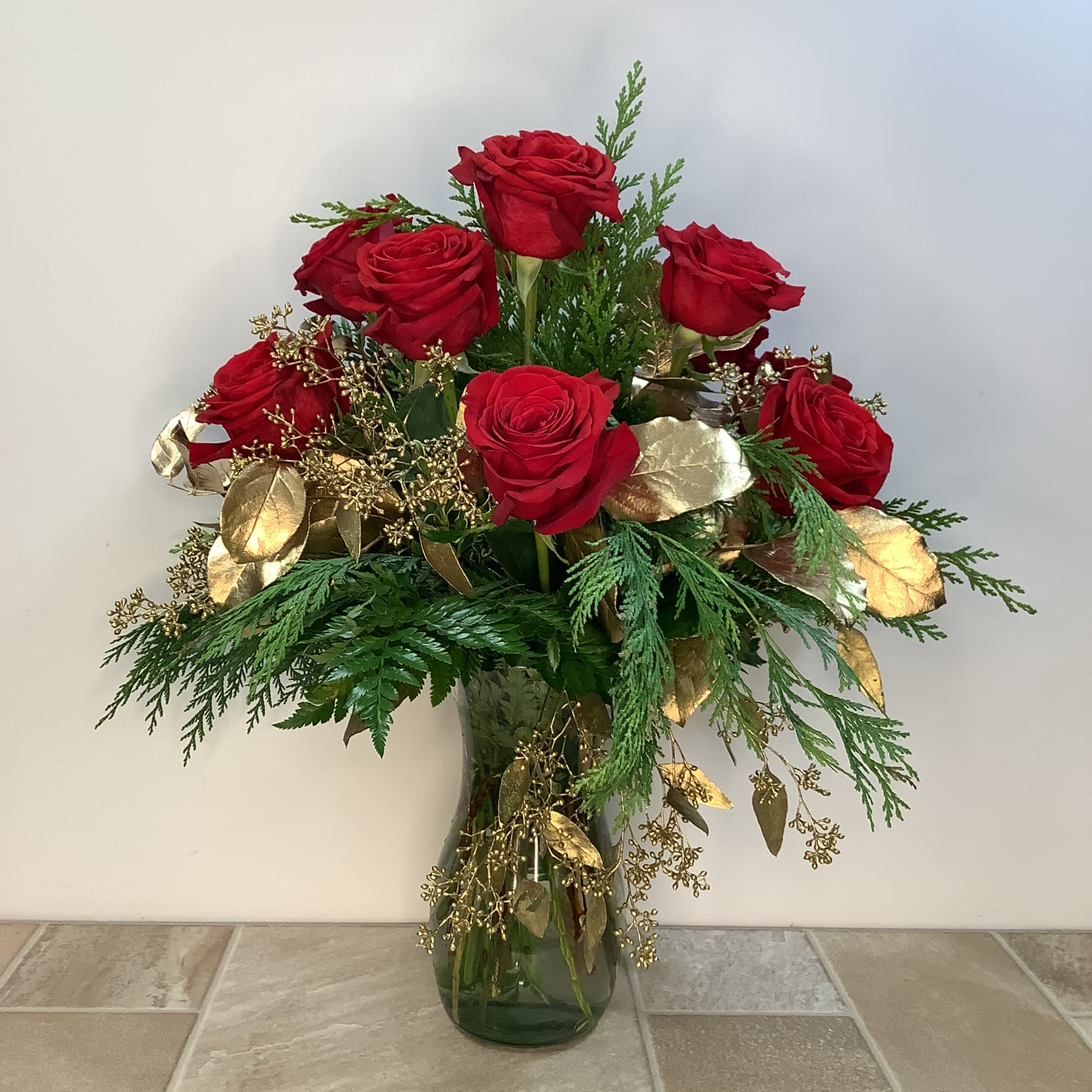 The Celebration Dozen - A most impressive bouquet of 12 long-stemmed red roses--certain to add a touch of elegance to any gathering. Fresh evergreens and golden eucalyptus complete this stunning arrangement. 