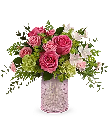 Sparkling Joy Bouquet - Delight Mom with Teleflora's Sparkling Joy Bouquet, delivered in a pink glass carafe with elegant beaded details. Paired with hot pink roses, pink spray roses, light pink alstroemeria, and other pretty blooms, this keepsake meets FDA tableware standards to safely serve and store drinks, adding beauty to any table year-round. Surprise her with Teleflora's Sparkling Joy Bouquet-hot pink roses, pink spray roses, light pink alstroemeria, green carnations, pink miniature carnations, bupleurum, leatherleaf fern, and parvifolia eucalyptus-artfully arranged in the food-safe pink glass carafe with elegant beaded details, a cherished gift for Mom. Orientation: All-Around 
