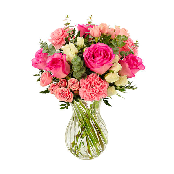 Bloom Envy Bouquet  - Mom will almost certainly invite all her friends to see this bright and beautiful bouquet…then watch with glee as envious expressions appear on their faces. Roses, mini carnations and eucalyptus are imaginatively arranged in a swirl glass vase. 