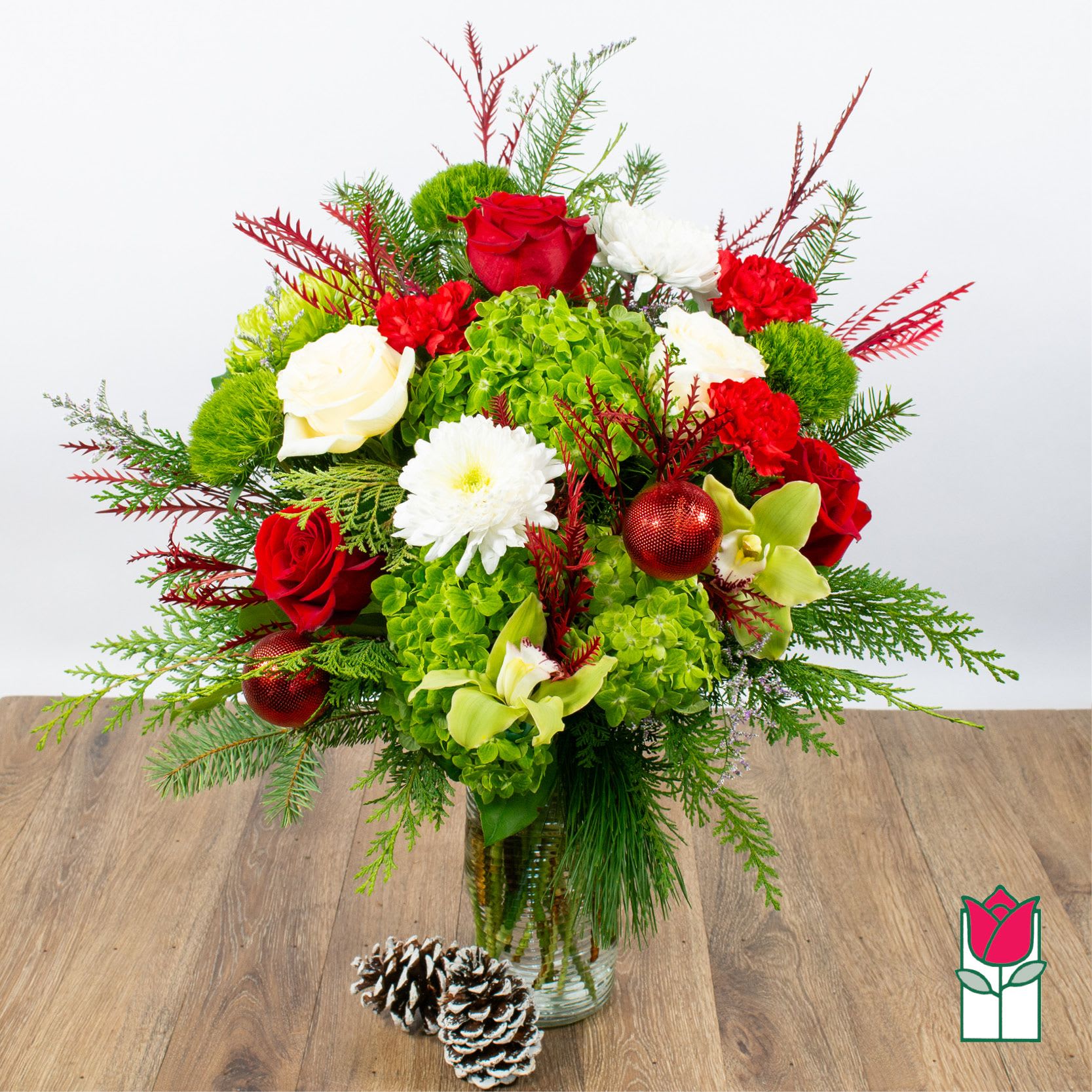 Beretania's Holiday Happiness Bouquet (Seasonal Flowers Vary) - Introducing the enchanting Christmas Floral Collection at Beretania Florist, where the spirit of the season blossoms with every petal. Our commitment to quality shines through in every handcrafted arrangement, making each piece a masterpiece of fresh premium flowers and a variety of fragrant Christmas greens.  Embrace the magic of the holidays with our exquisite Christmas floral items. While the final creation may showcase a unique selection of fresh blooms and foliage, the end result is guaranteed to resemble the stunning product photos on our website. Each arrangement is thoughtfully designed to capture the essence of Christmas, whether you prefer the traditional reds and greens or a more modern interpretation of the season.  At Beretania Florist, we understand the importance of timely delivery during the holiday rush. That's why we offer fast and reliable delivery services in the Honolulu area, ensuring your festive arrangements arrive at their destination in perfect condition. Additionally, for those who prefer a more hands-on approach, we offer free local pickup for your convenience.  Planning ahead is a breeze with Beretania Florist. Customers can preschedule their delivery or pickup orders in advance, allowing you to reserve your preferred date and time, so your Christmas floral items are ready when you need them most.