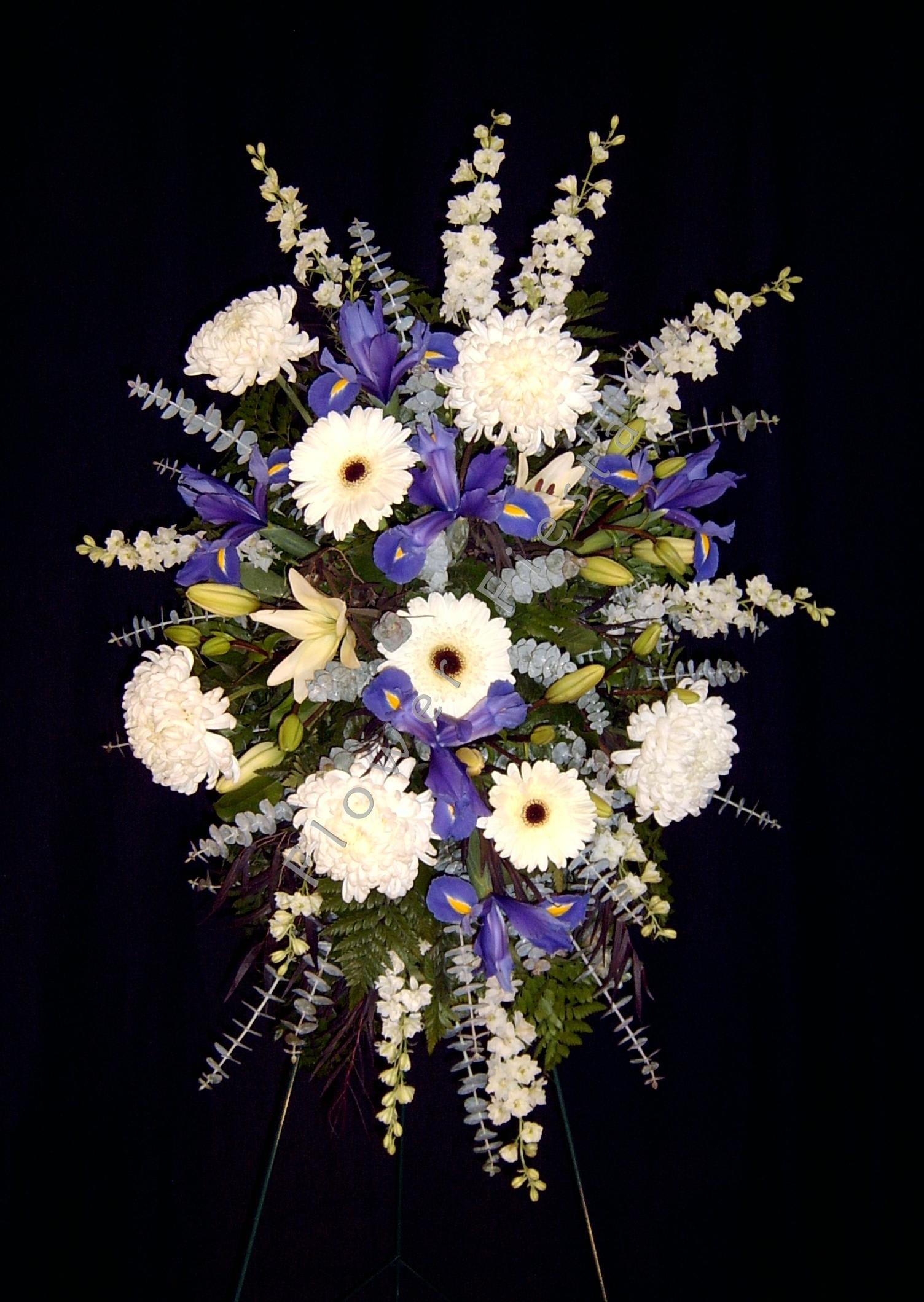 Medium Standing Spray, Color may vary - Designer's Choice of Colors and Flowers. We offer an affordable solution for memorial services and funerals with our Designer's Choice selection. This item comes on a standing easel and includes an assortment of fresh flowers and greenery. Please leave the style, color and flower selection up to the Designer in order to receive this price break.  For specific colors and flowers, please phone in your order.