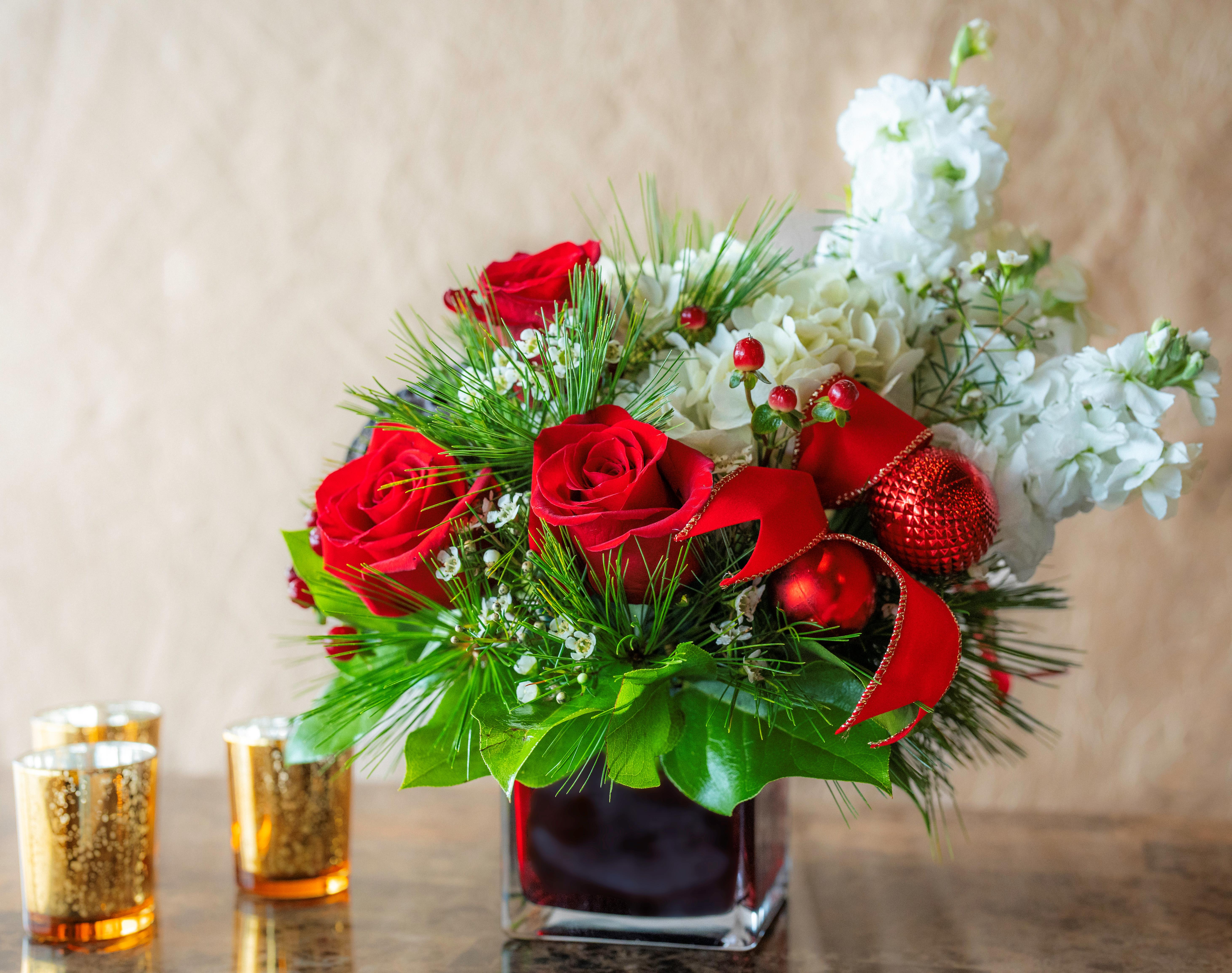 Holiday Cheer  - This perfect combination of lush hydrangea, roses and all of the holiday trimmings is sure to bring the best of warm holiday wishes to someone special on your list. Whether it is to the host with the most, or a best friend who has it all, share the joy of our Holiday Cheer today! 